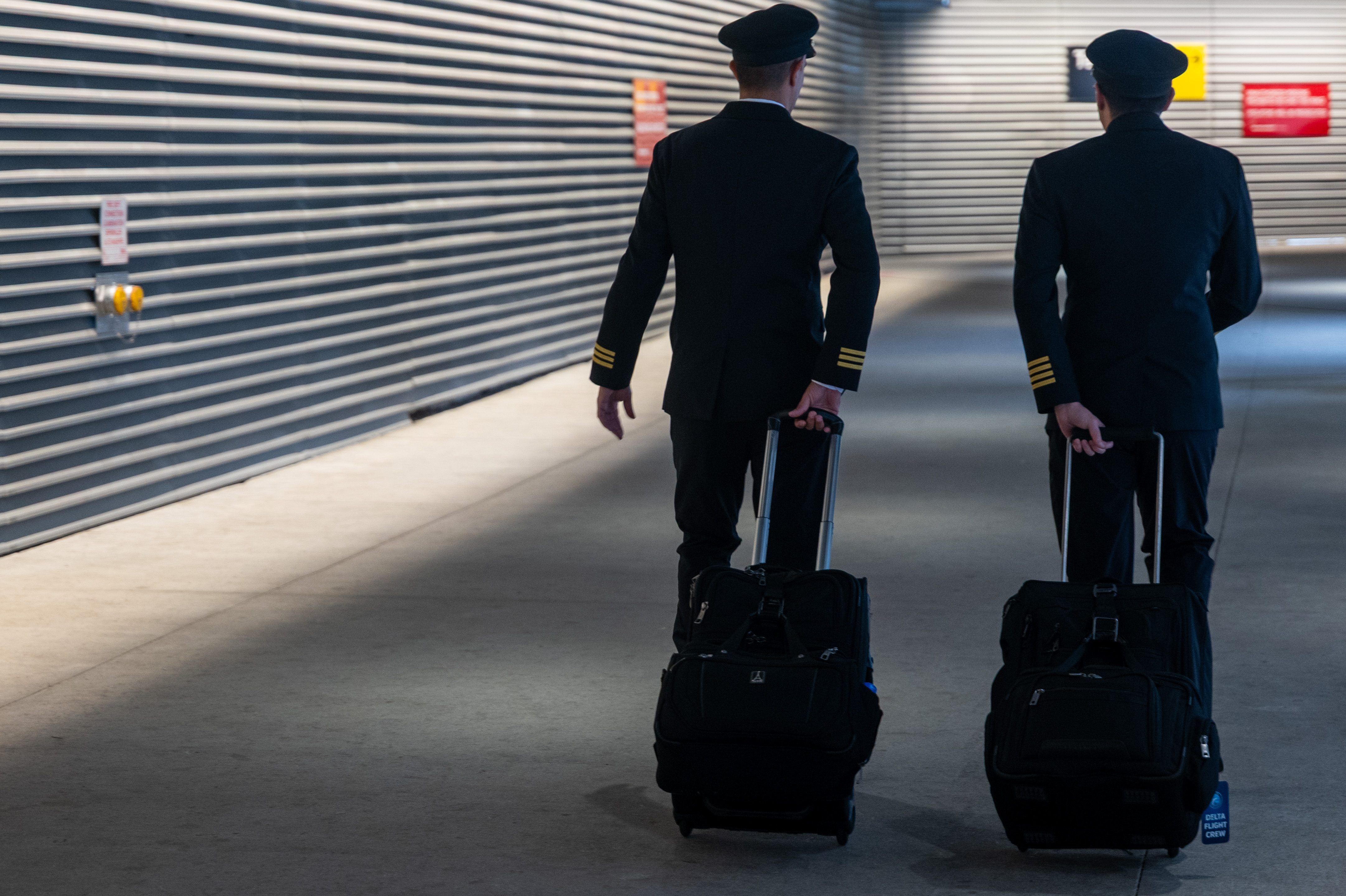 Pilots walk through LaGuardia Airport on November 10, 2025 in New York City | Source: Getty Images