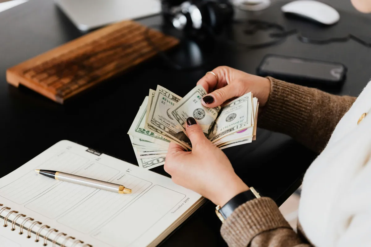 A person counting money | Source: Pexels