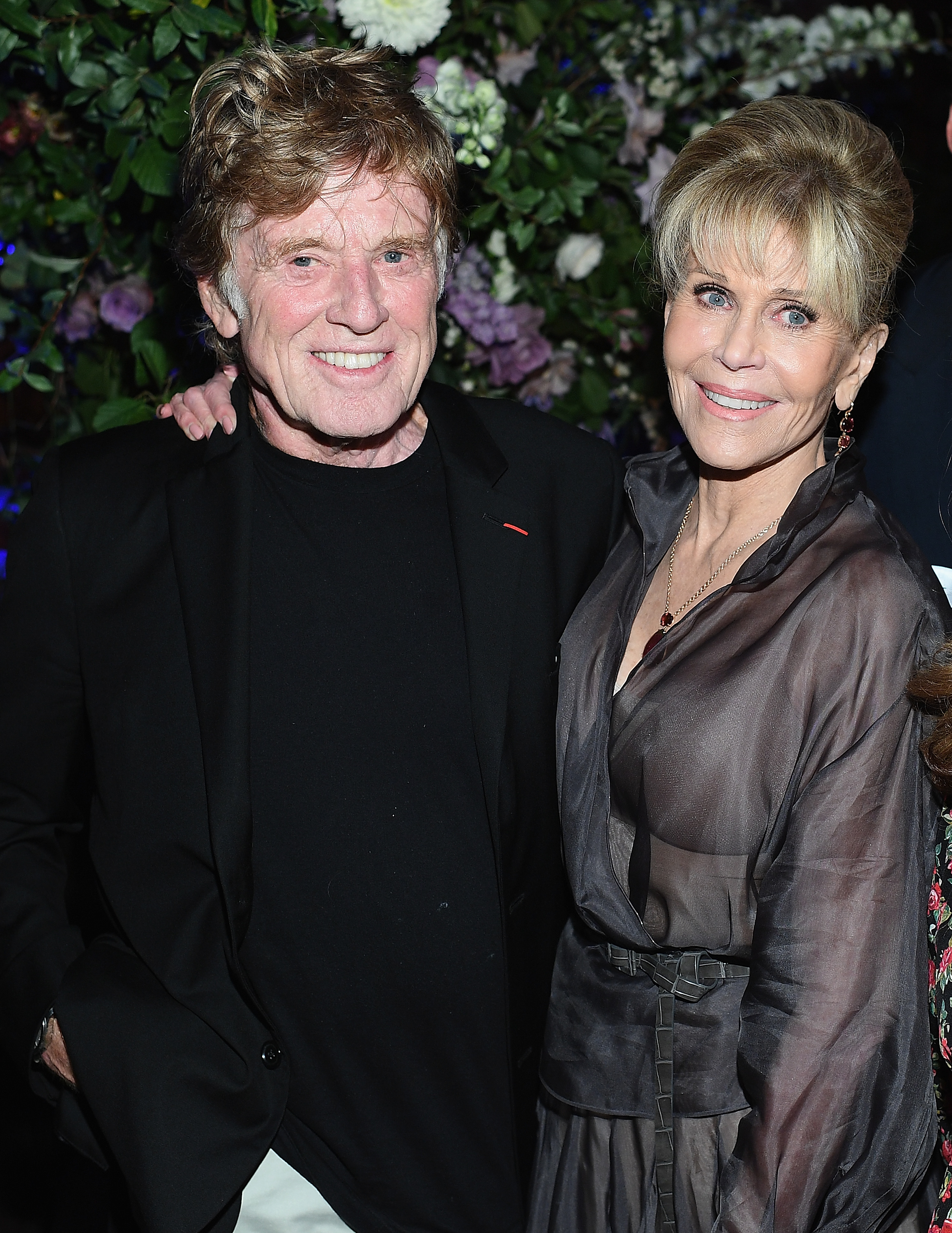 Robert Redford and Jane Fonda attend the premiere of "Our Souls at Night" at The Oak Room in New York City. They share warm smiles as Fonda wraps her arms across his shoulders while they pose together.