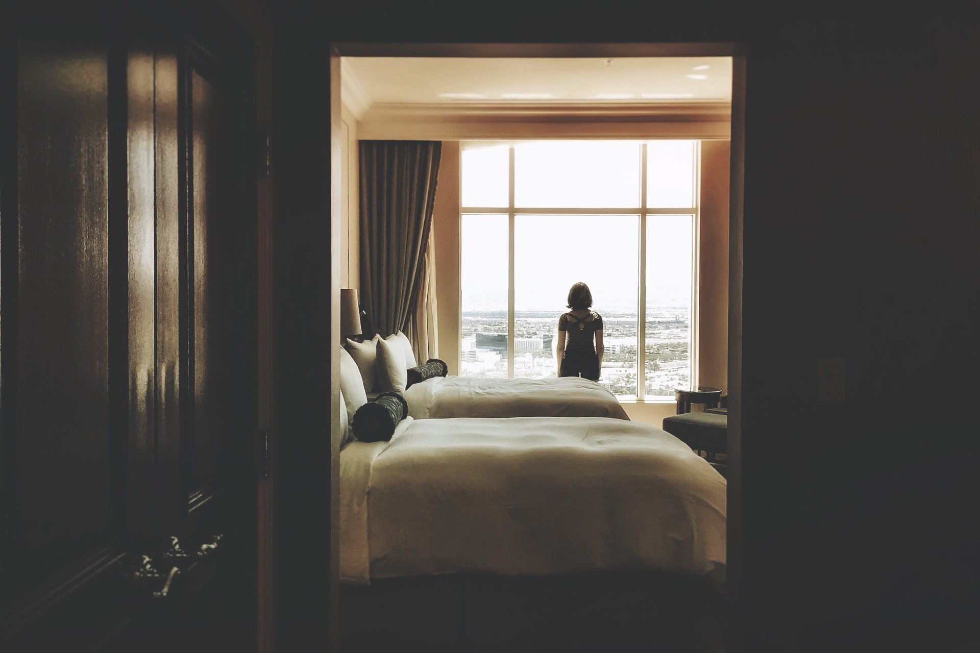Woman standing in a hotel room | Source: Unsplash