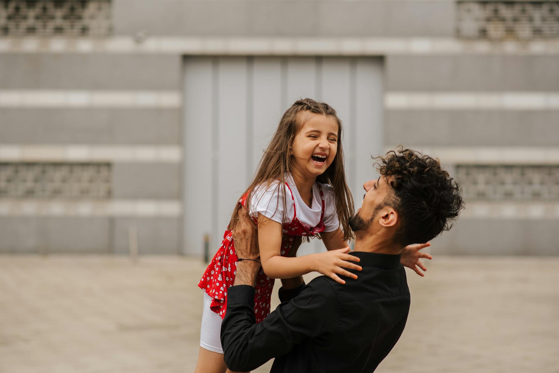 A man playing with a little girl | Source: Pexels