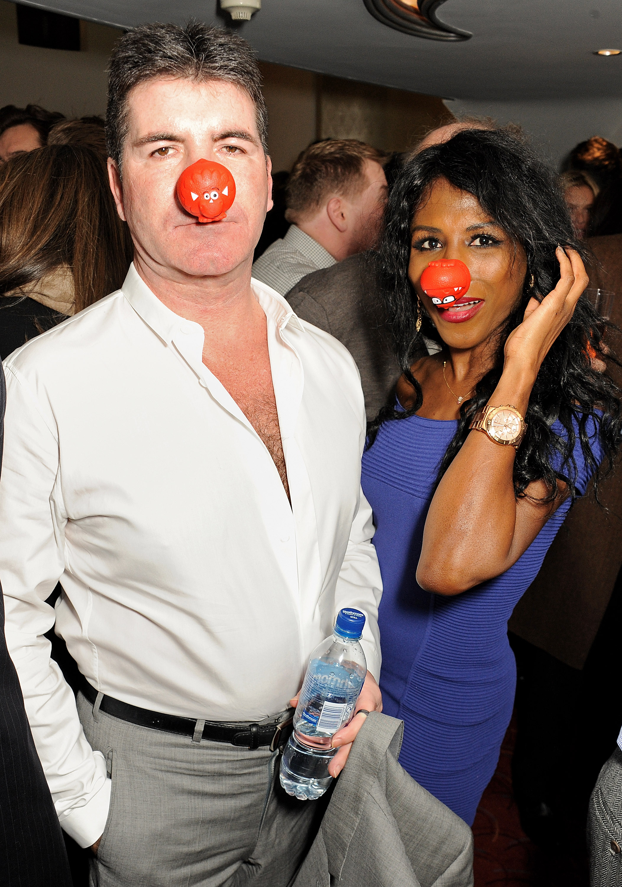 Simon Cowell (L) and Sinitta attend a gala performance of 'The Book Of Mormon' in aid of Red Nose Day at the Prince Of Wales Theatre, on March 13, 2013, in London, England. | Source: Getty Images