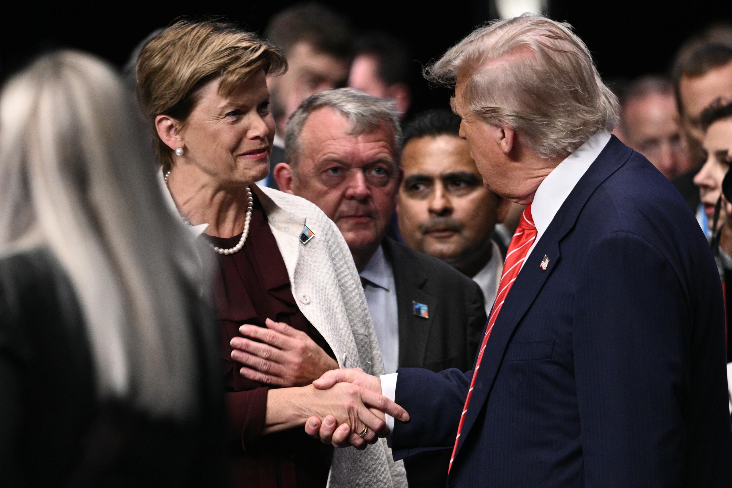 As Trump continues engaging in the room filled with powerful world leaders, he extends a greeting to Latvia’s Foreign Minister Baiba Braze. The moment reflects the ongoing diplomatic exchanges at the summit.