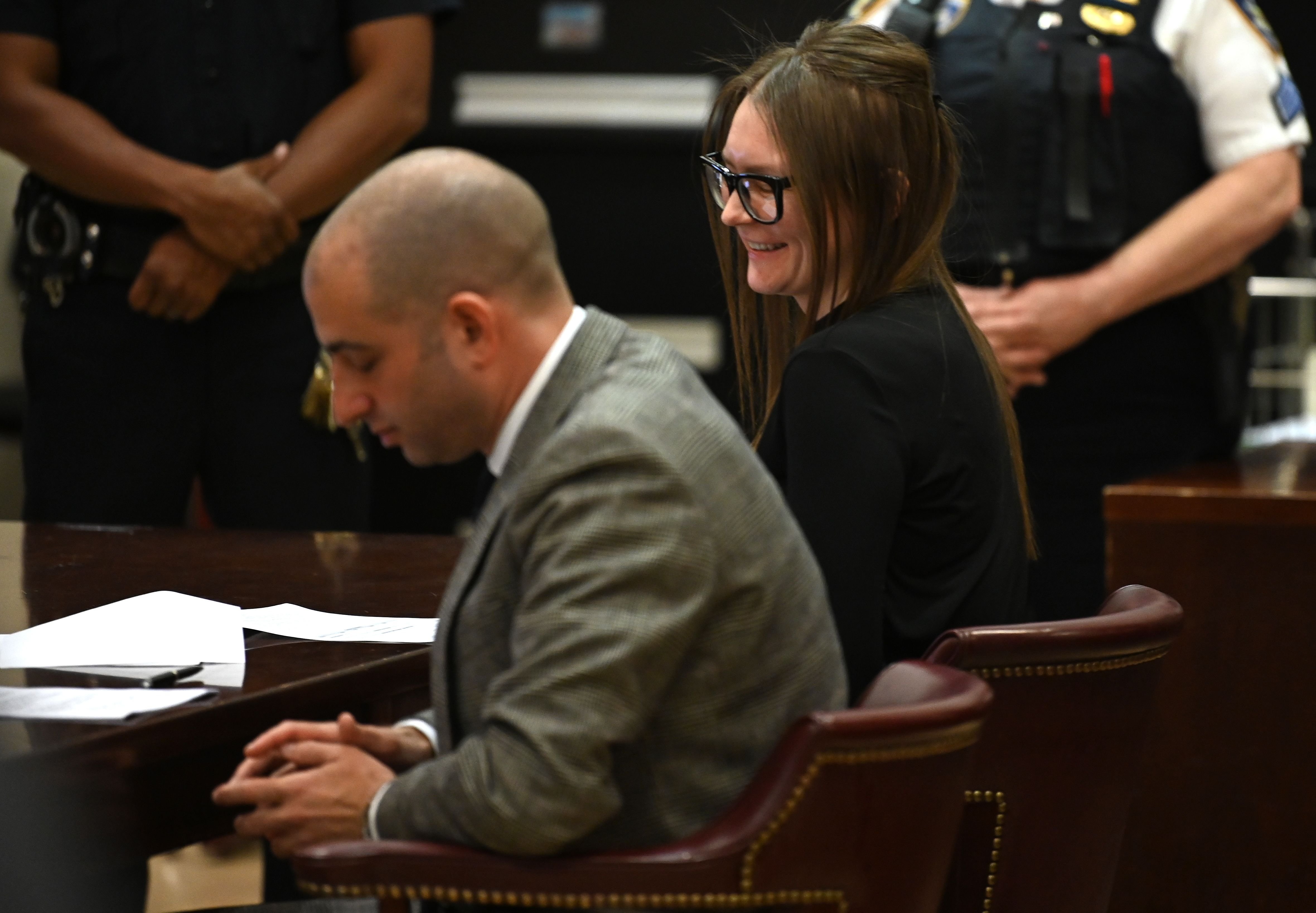 Anna Sorokin is pictured smiling next to her attorney Todd Spodek during he...