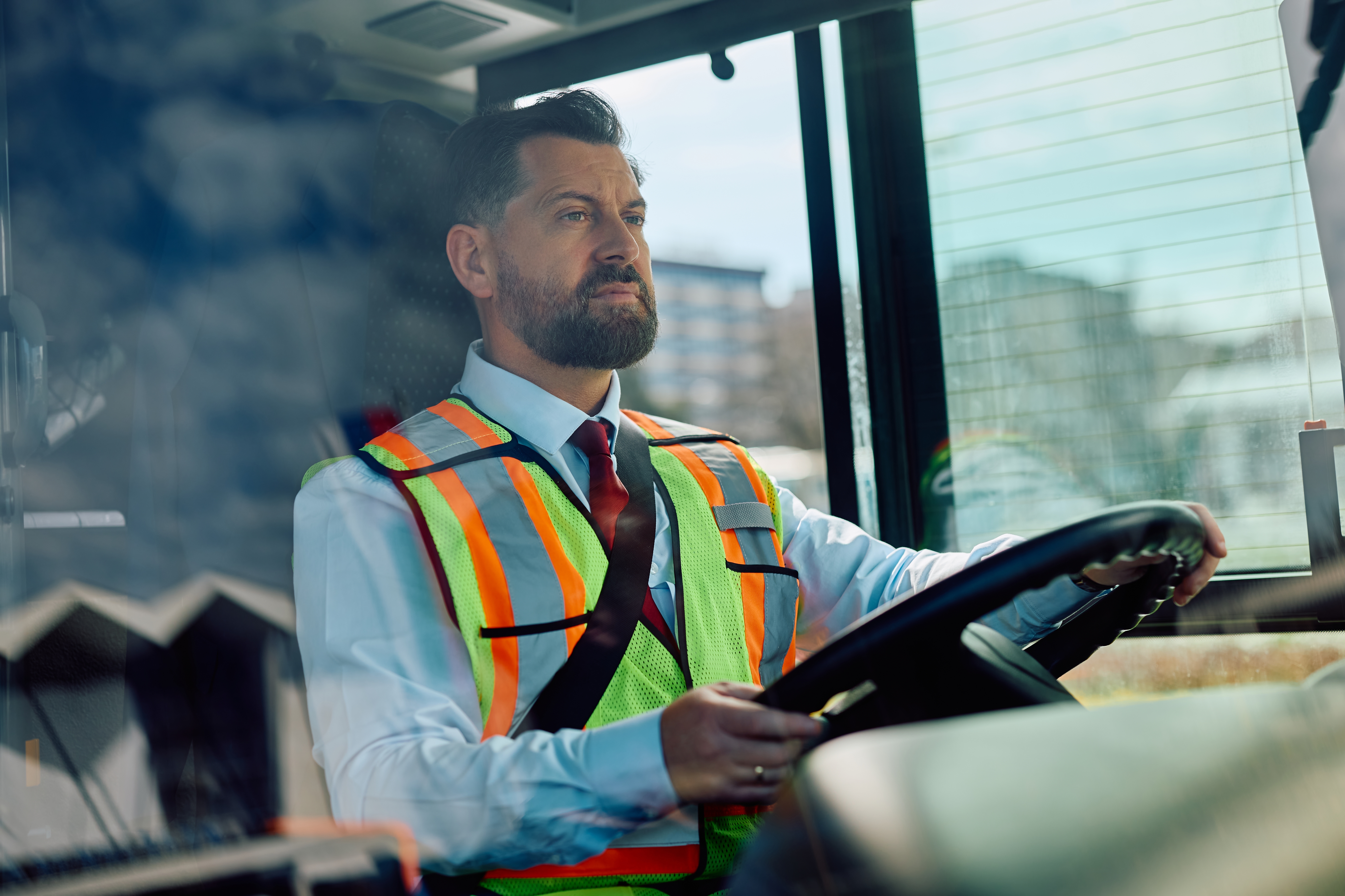 Bus driver driving a bus | Source: Shutterstock