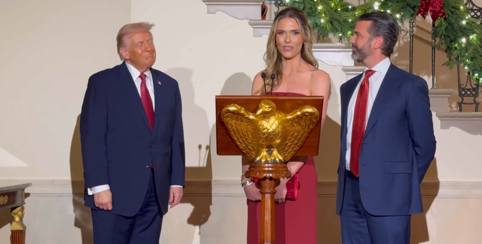 Donald Trump Jr. and his fiancée Bettina Anderson and President Donald Trump at the White House holiday event on December 15, 2025 | Source: X/LauraLoomer
