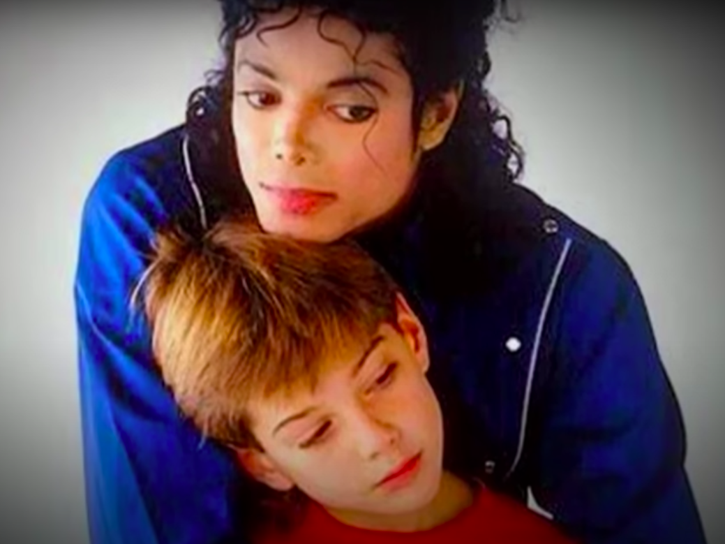 A screenshot of Michael Jackson embracing a young boy from a video posted on February 24, 2019 | Source: YouTube/60 Minutes Australia