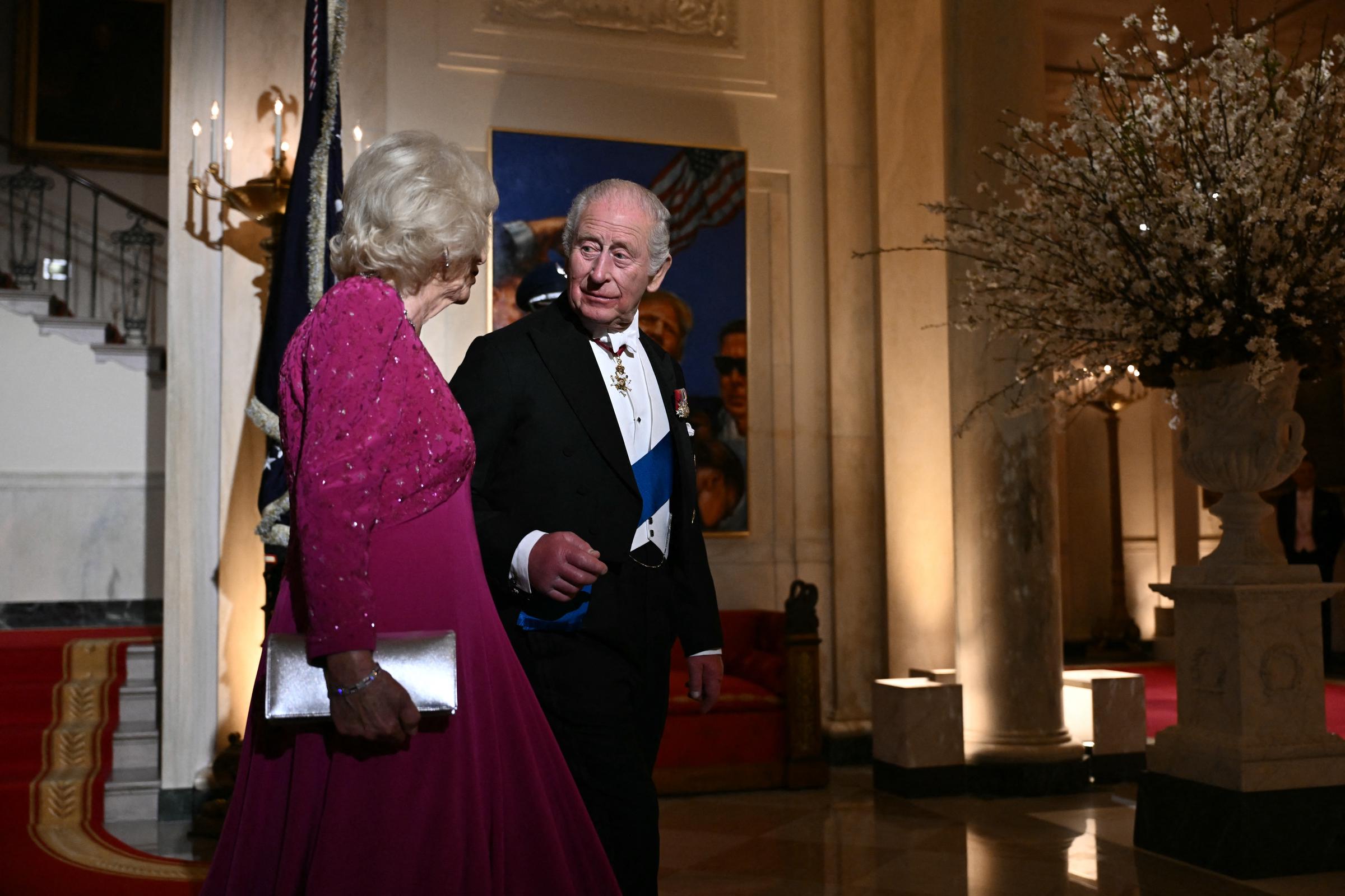 King Charles III and Queen Camilla arrive while conversing for a State Dinner hosted by Donald Trump and Melania Trump in the White House East Room, April 28, 2026. | Source: Getty Images