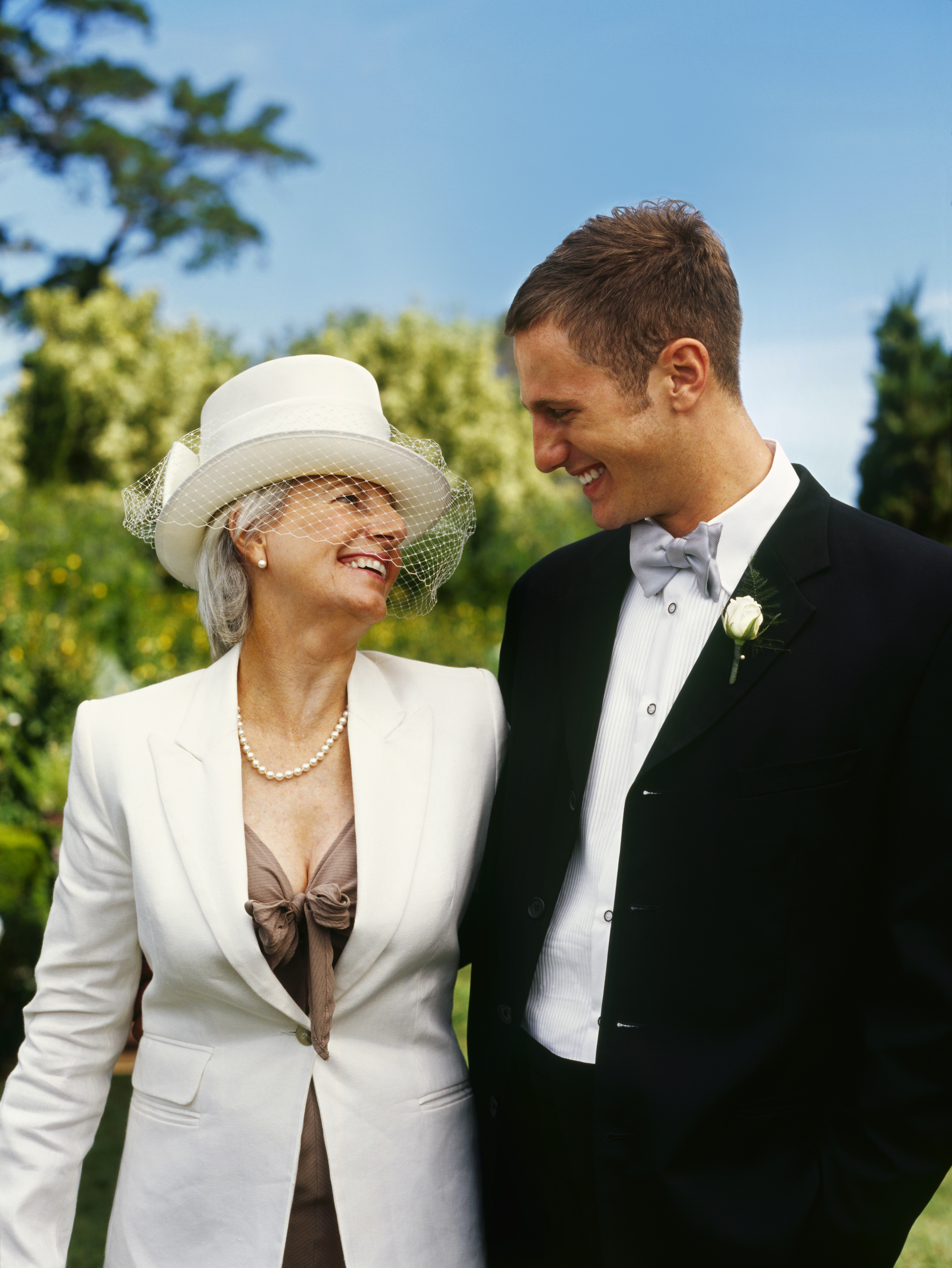 Groom smiling while standing with his mom | Source: Getty Images