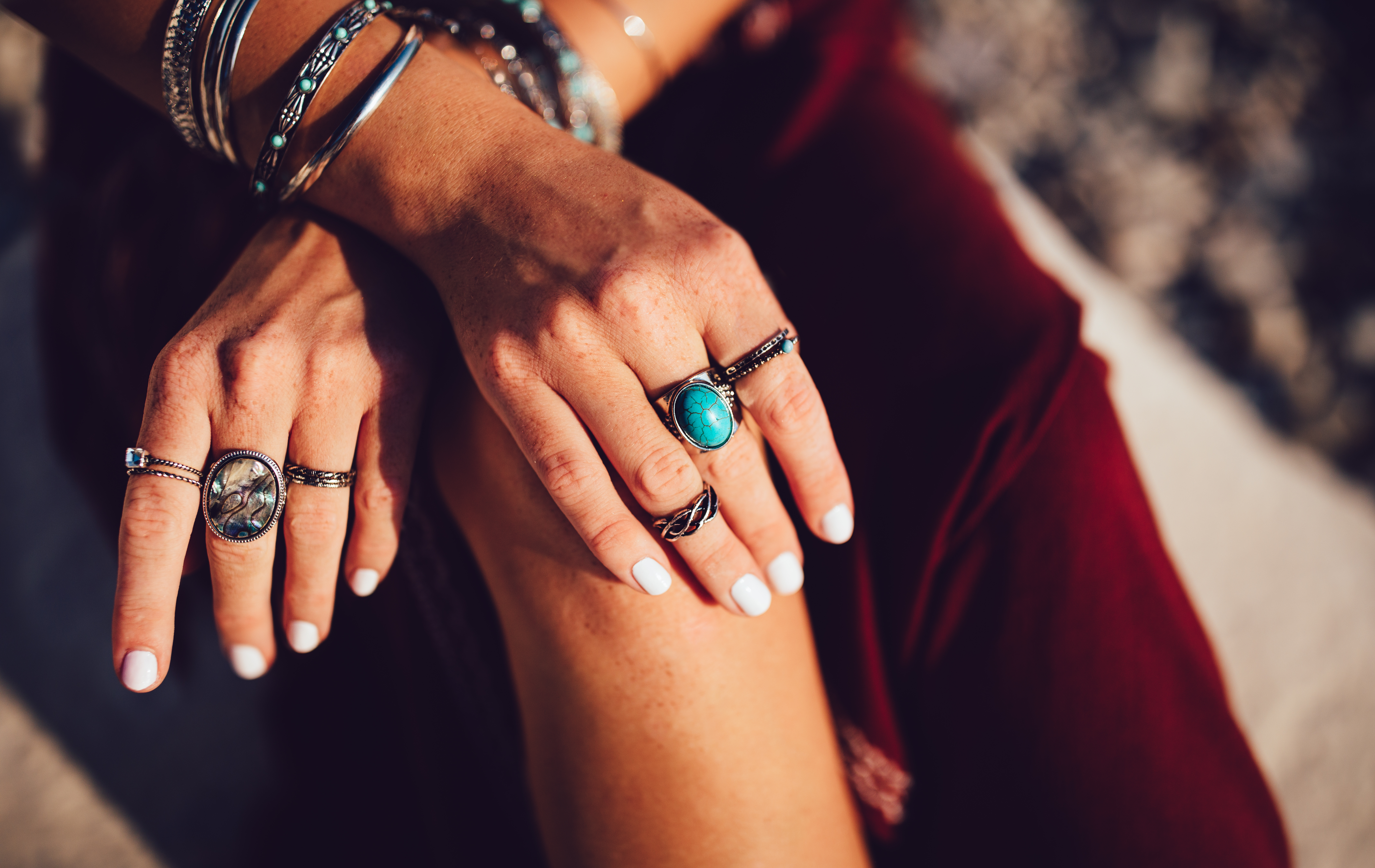 Close-up of a young woman's hands with boho style rings and bracelets.  | Source: Getty Images