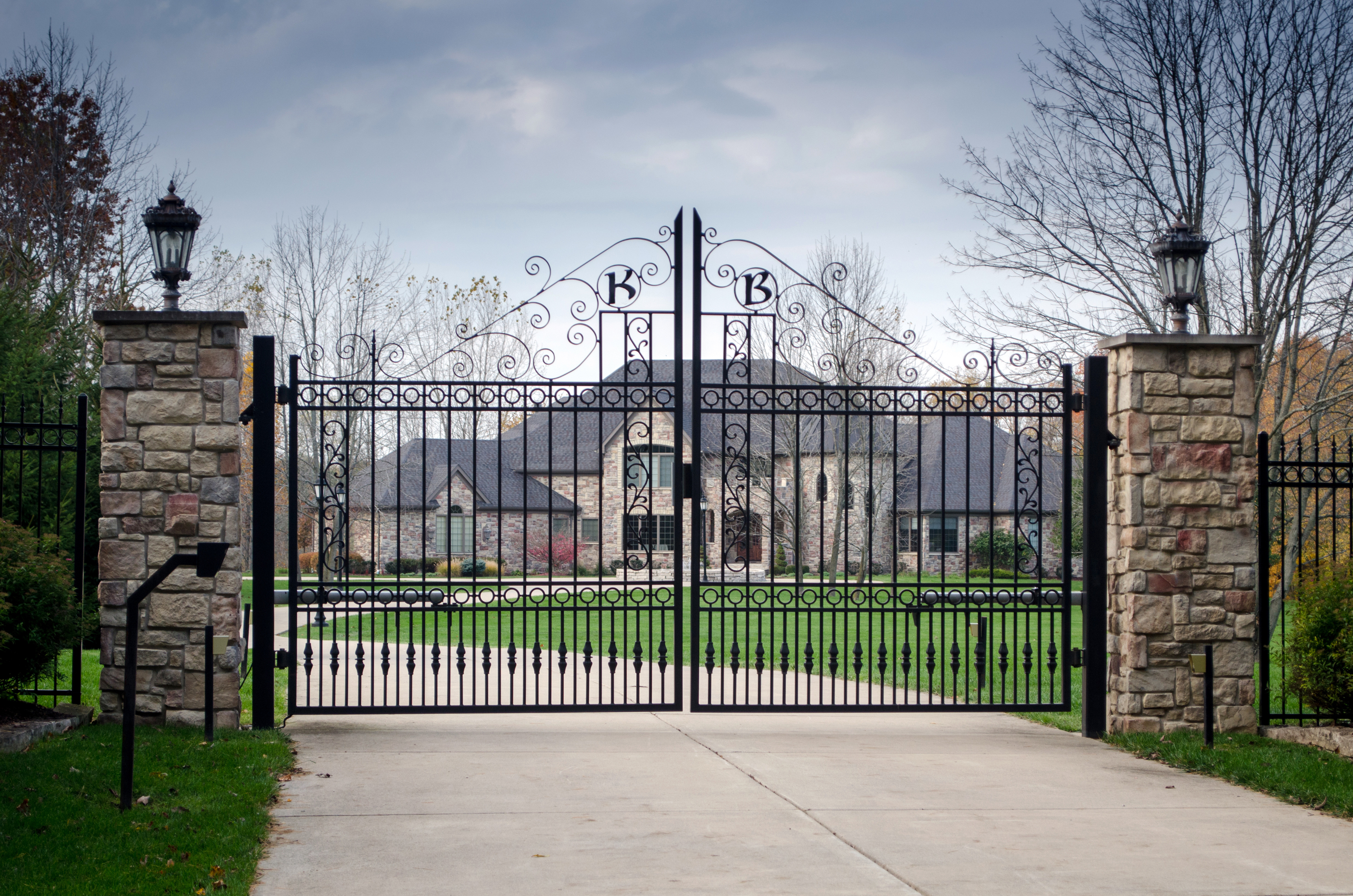 Fancy large mansion behind a locked gate | Source: Shutterstock.com