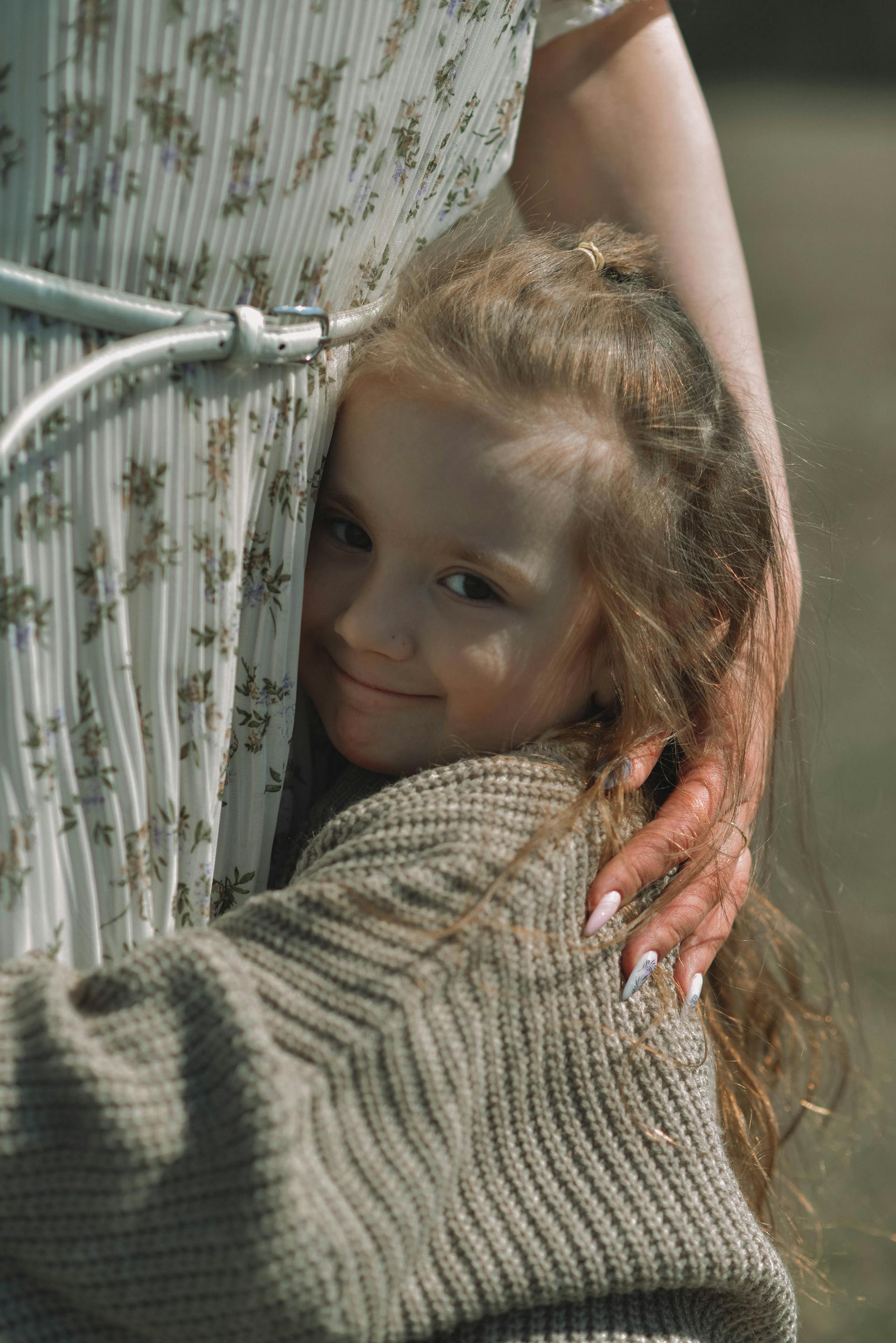 A young girl hugging her mom | Source: Pexels