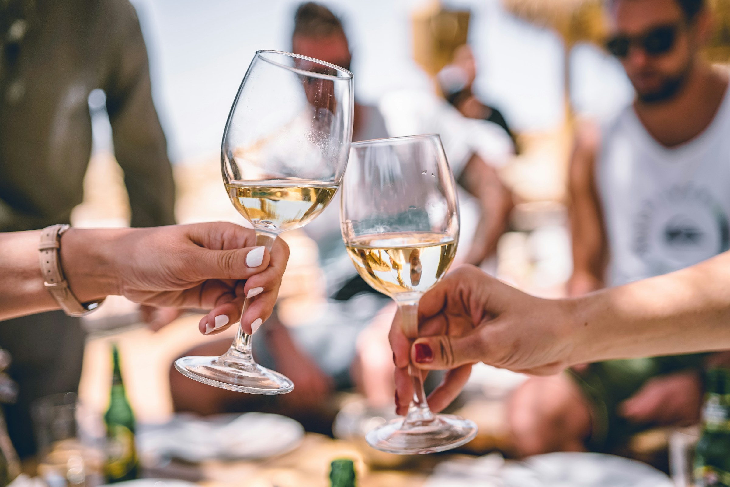 Two women holding wineglasses | Source: Unsplash