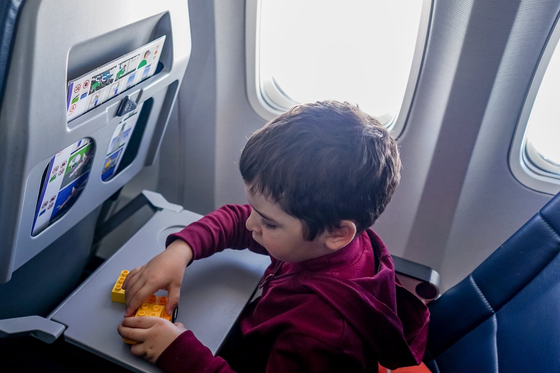 A boy playing with toys in an airplane | Source: Pexels