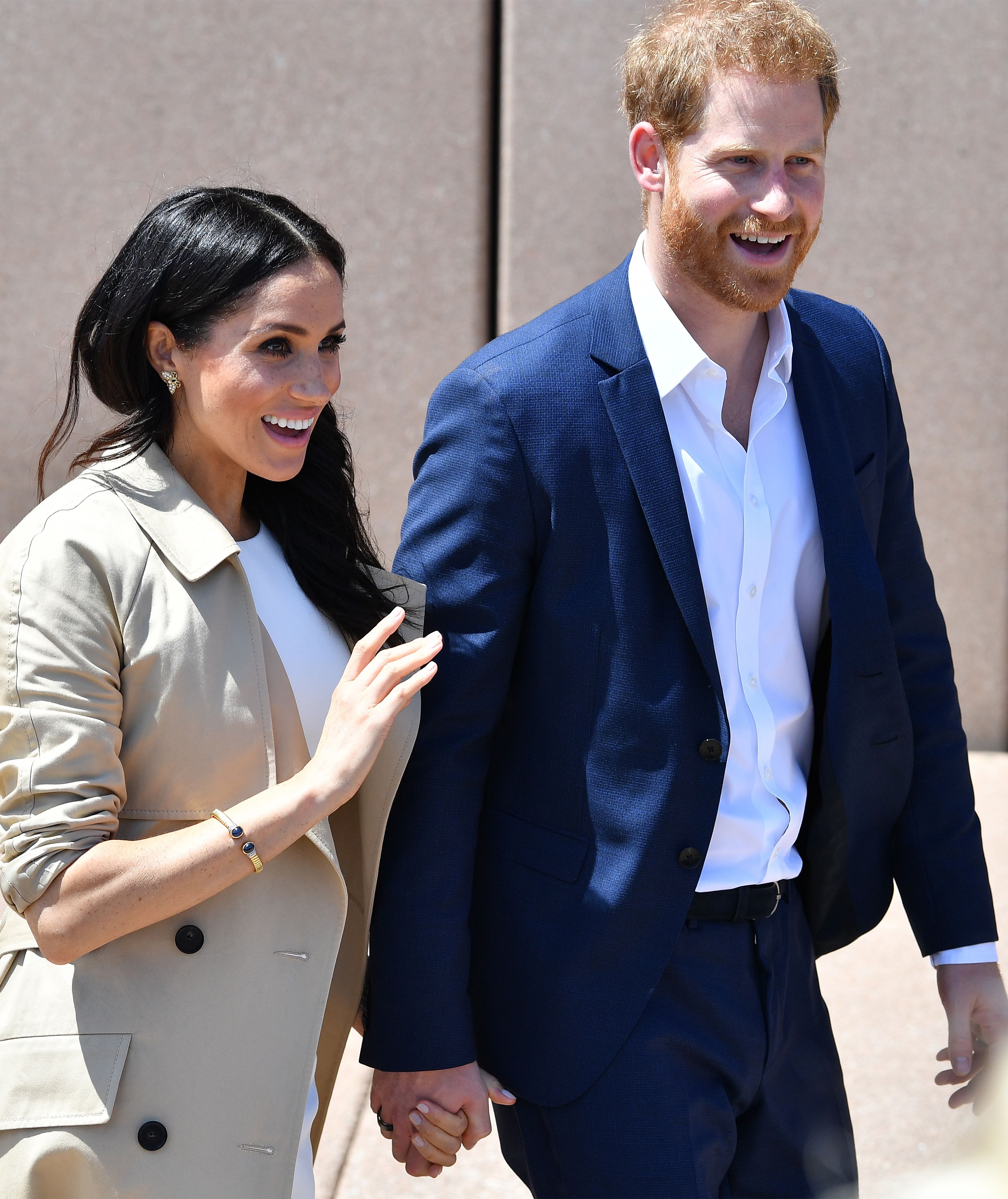Prince Harry and Meghan Markle walk outside the Sydneys iconic Opera House on October 16, 2018 in Sydney Australia. Markle wears a gold bracelet which belonged to Prince Harry's mother, the late Princess Diana | Source: Getty Images 
