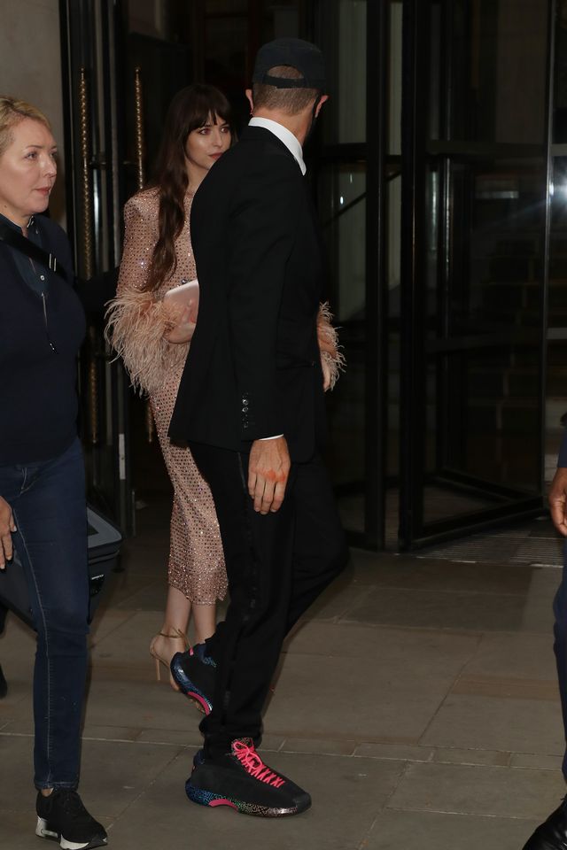 Chris Martin and Dakota Johnson seen leaving The Corinthia Hotel ahead of the "The Lost Daughter" UK Premiere during the 65th BFI London Film Festival at The Royal Festival Hall on October 13, 2021 in London, England | Source: Getty Images
