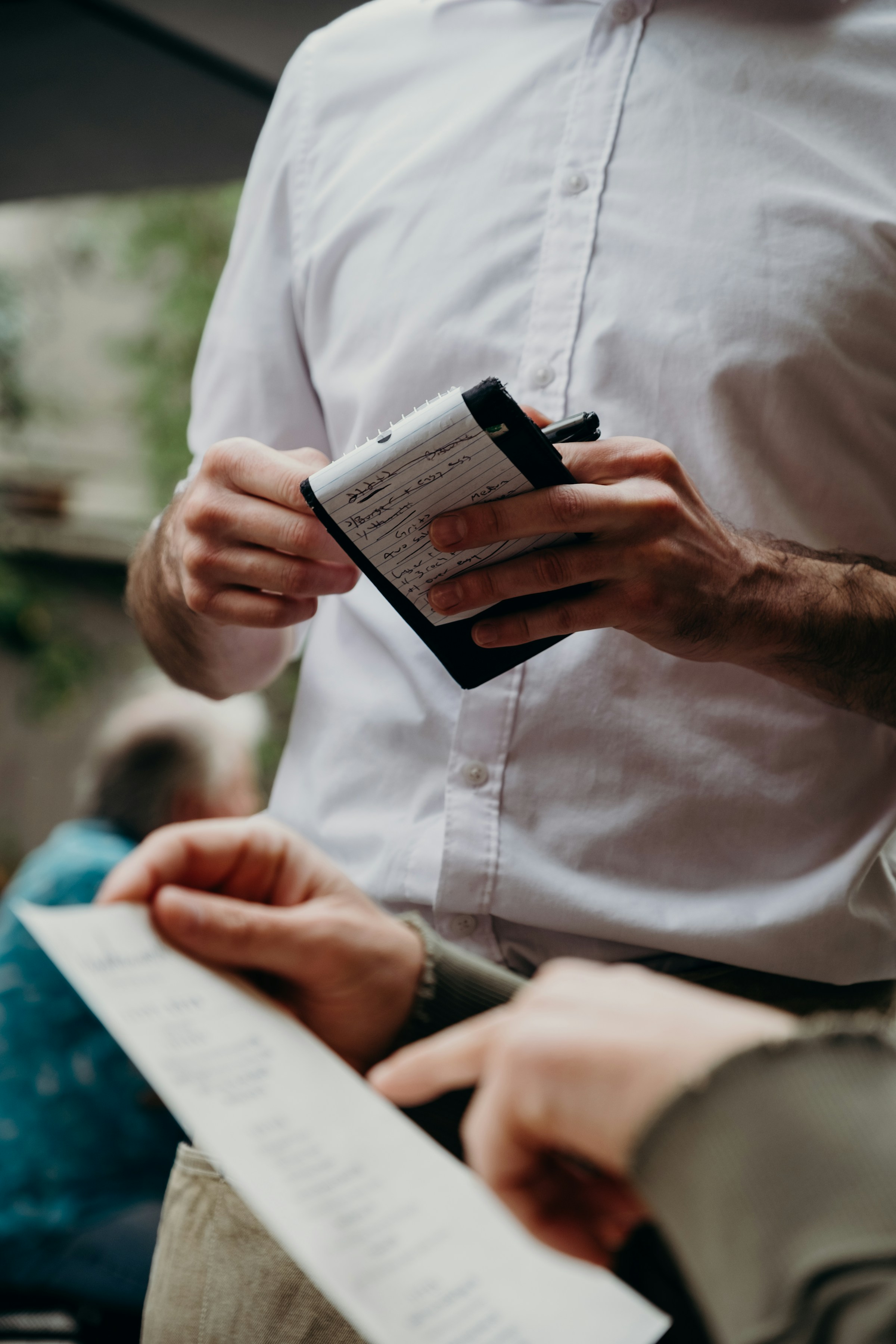 A waiter holding a notepad | Source: Unsplash