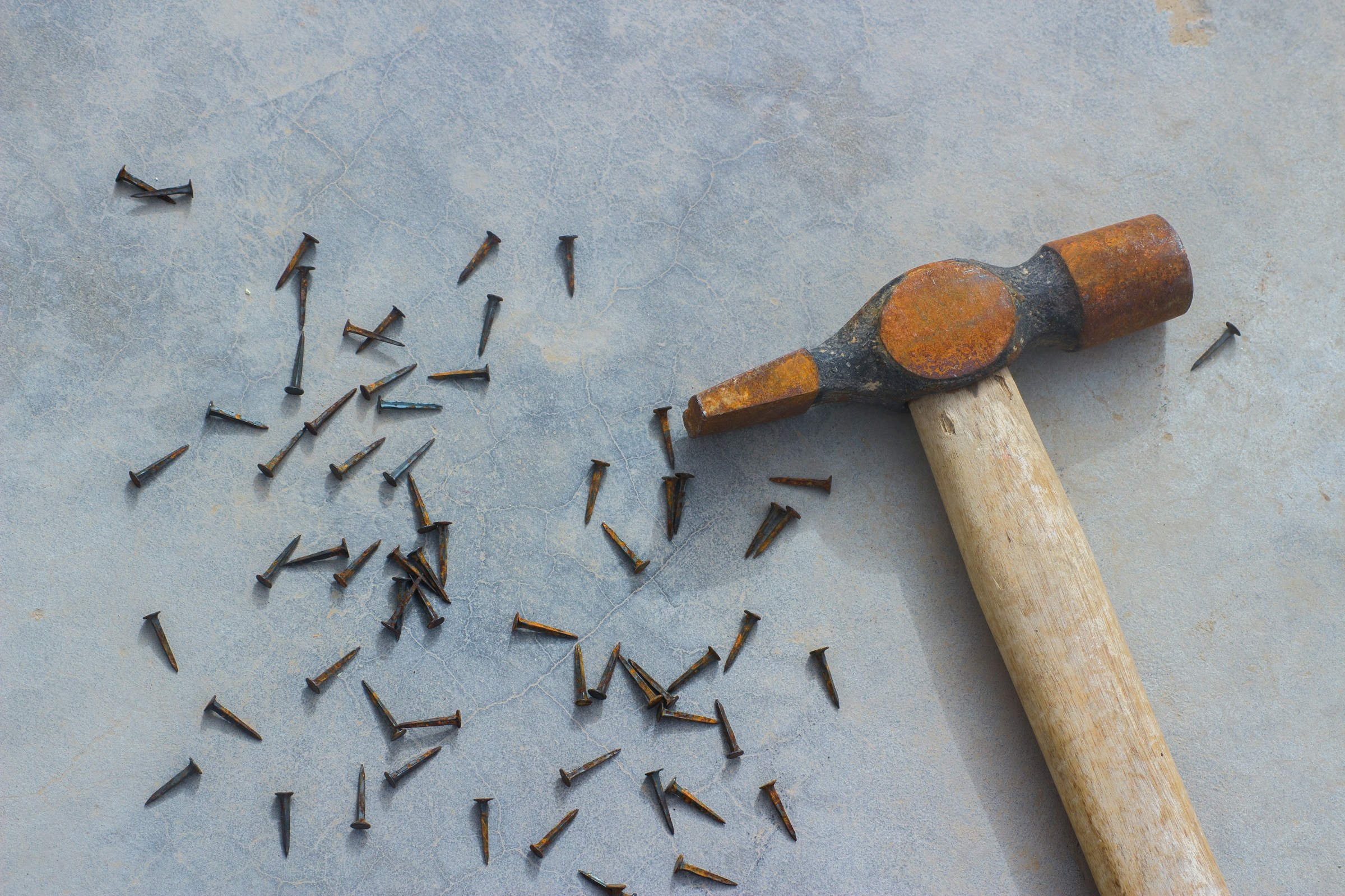 Nails scattered near a hammer | Source: Unsplash