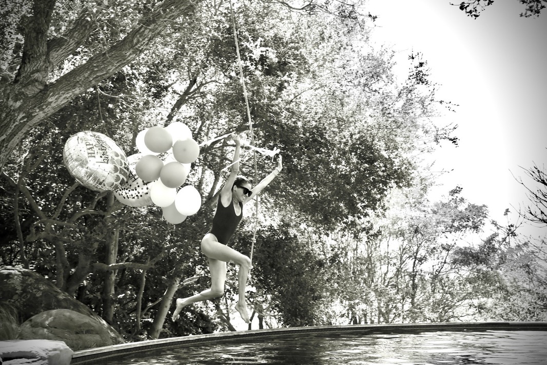 Meghan Markle rang in her 45th birthday with a dramatic pool plunge, balloons in hand and a caption thanking fans for their love. | Source: Instagram/meghan