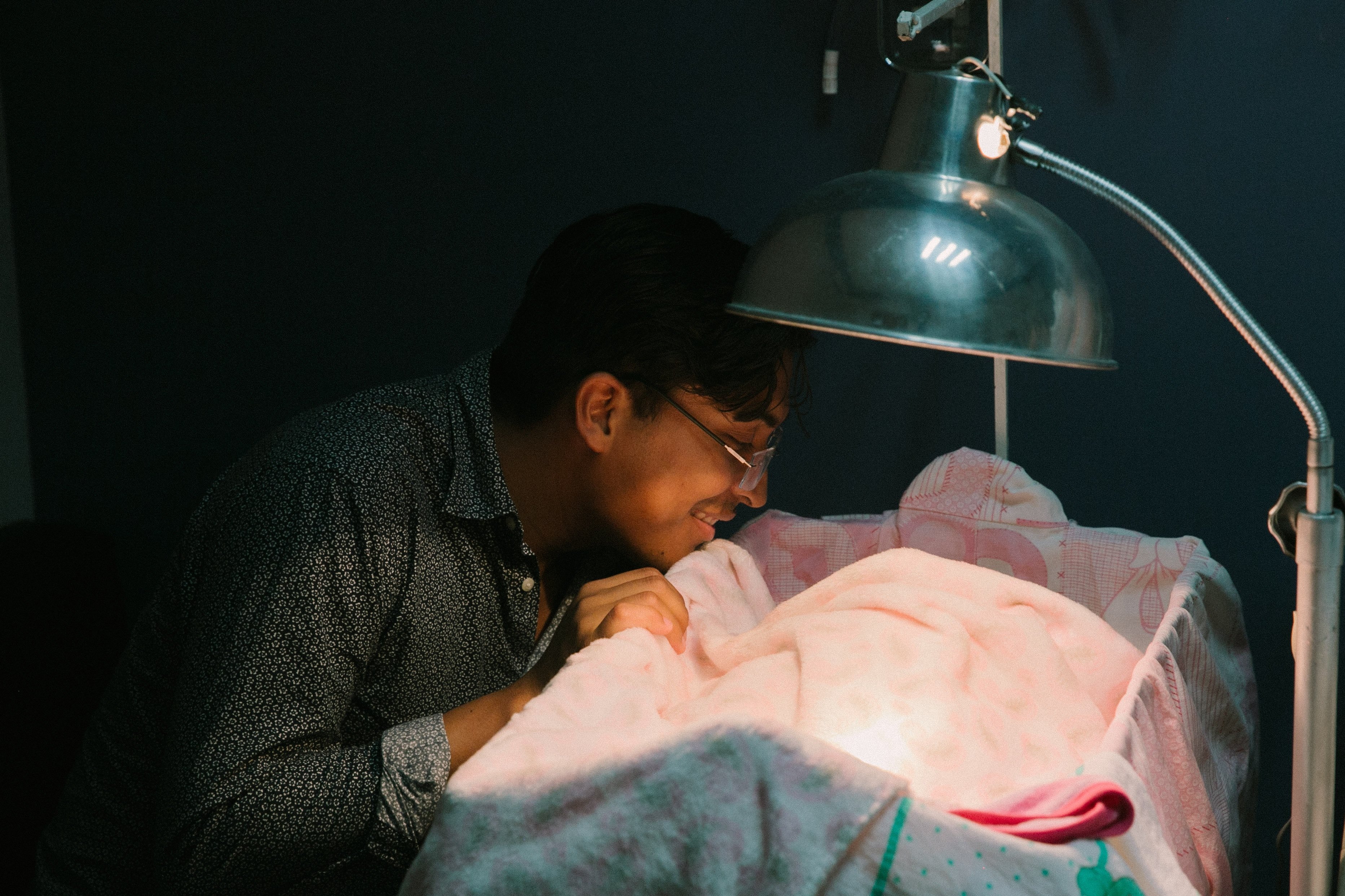 A young man watching a baby at a NICU | Photo by César Abner Martínez Aguilar on Unsplash