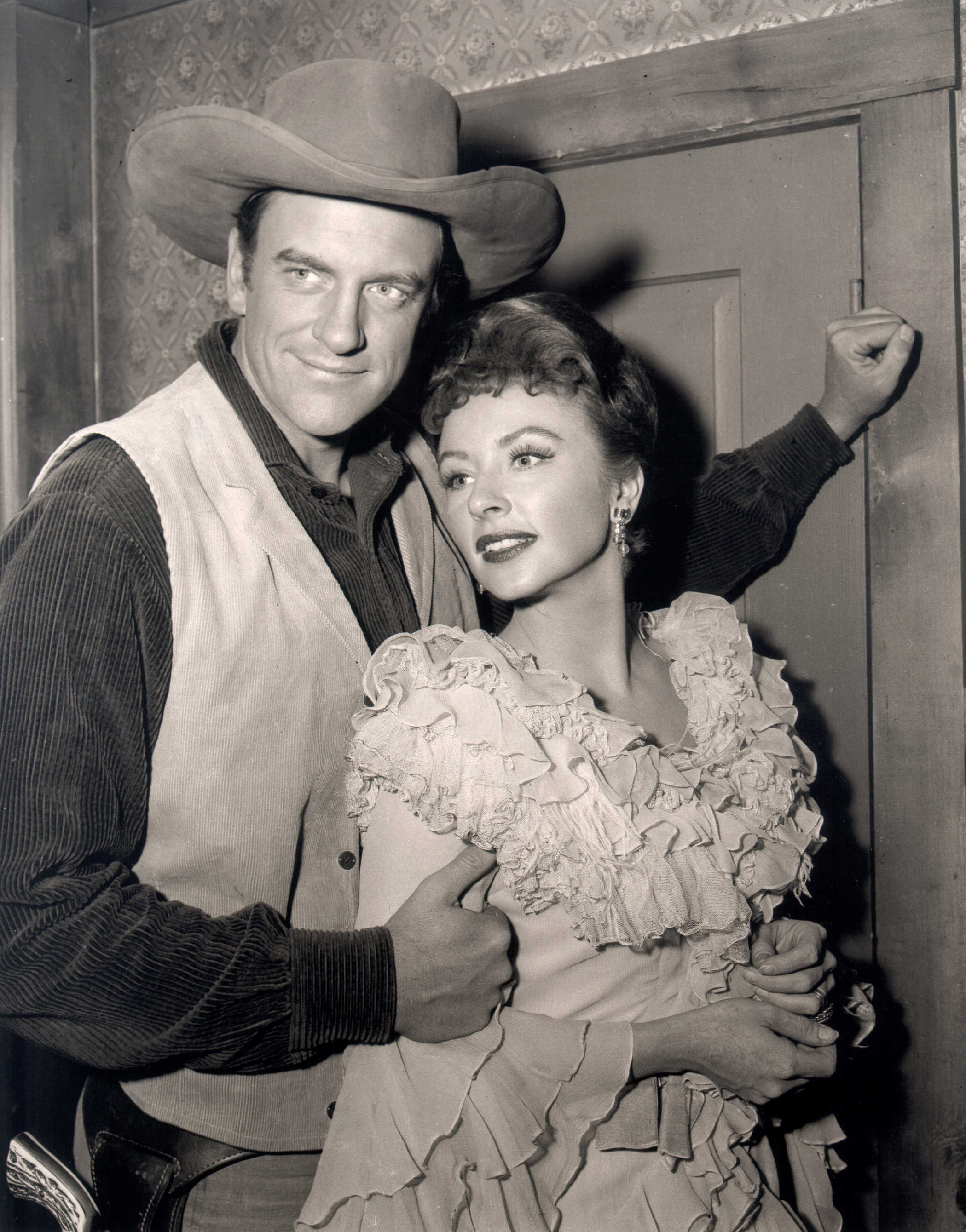 James Arness and Amanda Blake as they embrace and pose in costume from the CBS television western "Gunsmoke" on December 11, 1956. | Source: Getty Images