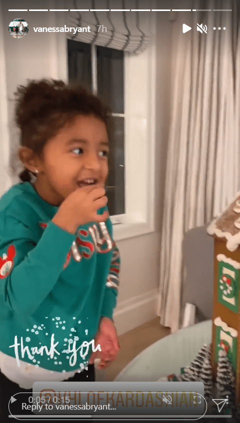 Kobe Bryant's daughter, Bianka, seen taking a bite off the gingerbread house | Photo: Instagram/vanessabryant