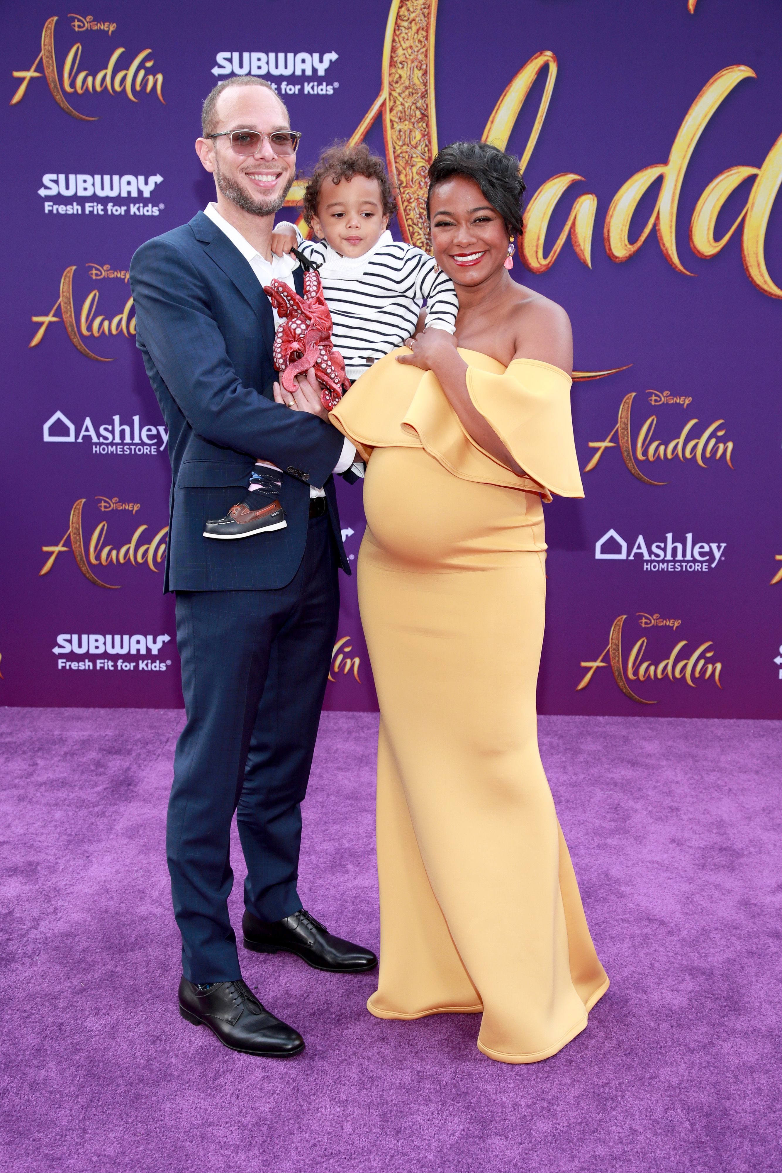 Tatyana Ali, husband Vaughn Rasberry, and son Edward at the premiere of "Aladdin" in 2019 in Los Angeles | Source: Getty Images