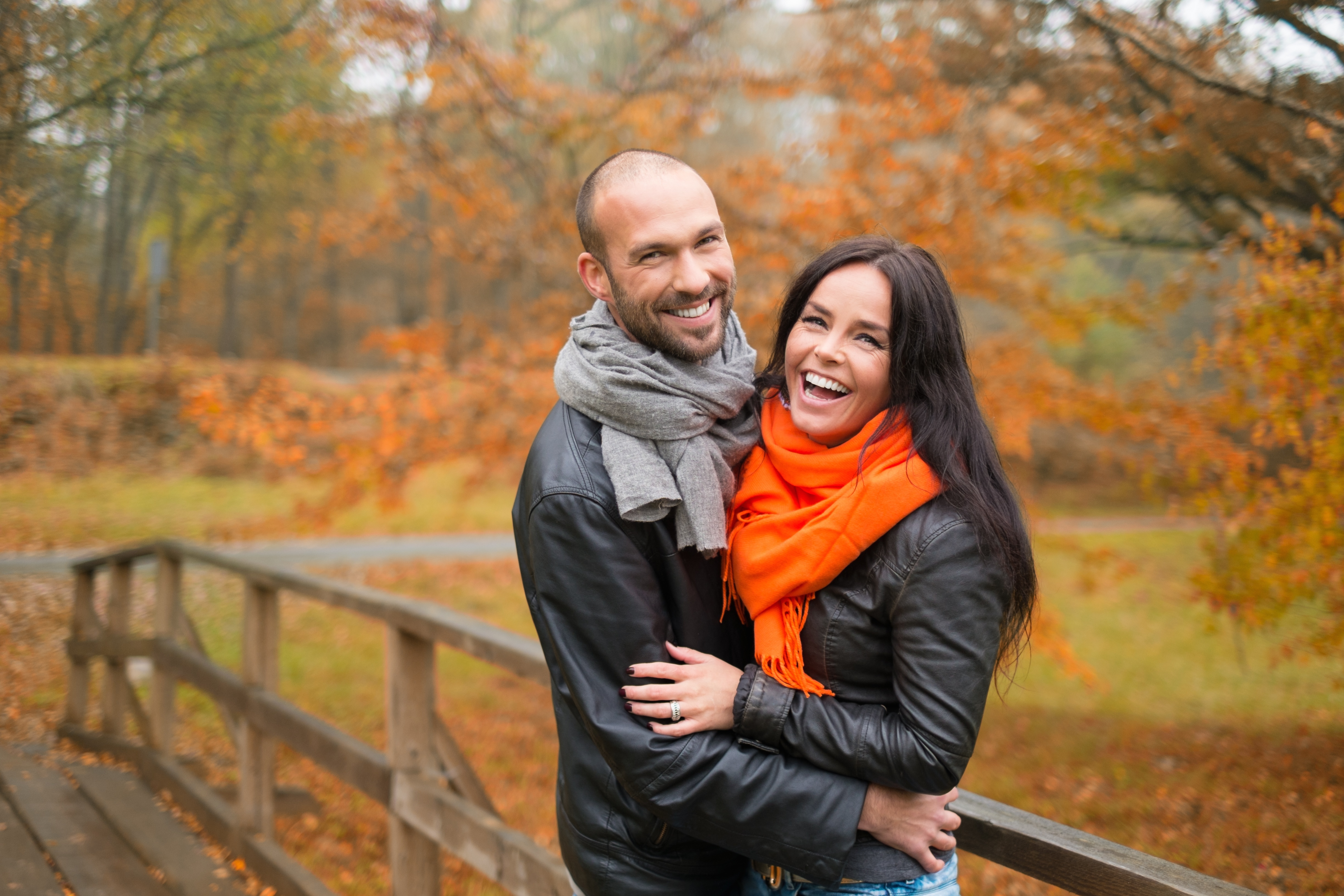 A happy couple posing outside in autumn | Source: Shutterstock