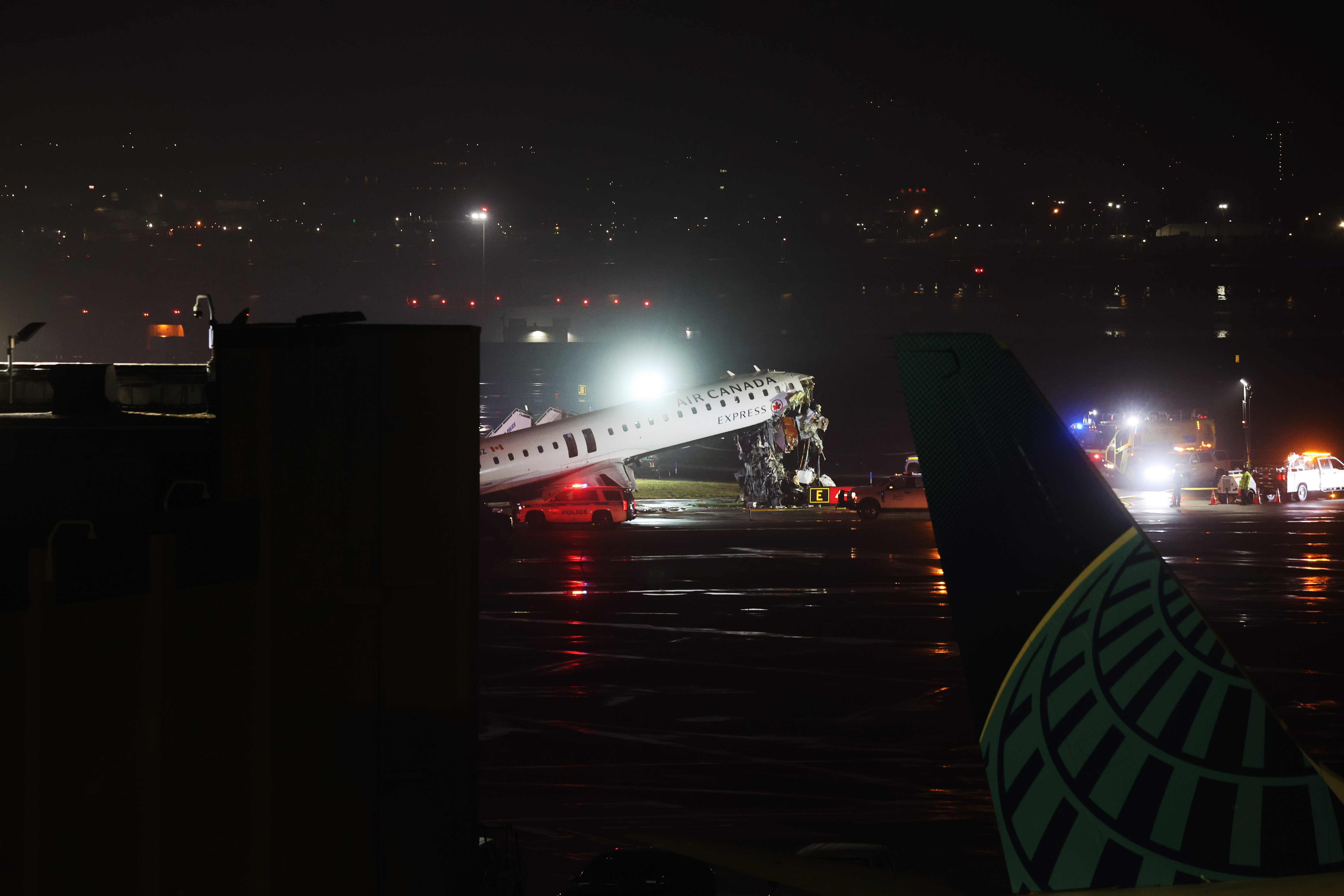 n Air Canada Express plane sits on the tarmac after it collided with a fire truck | Source: Getty Images