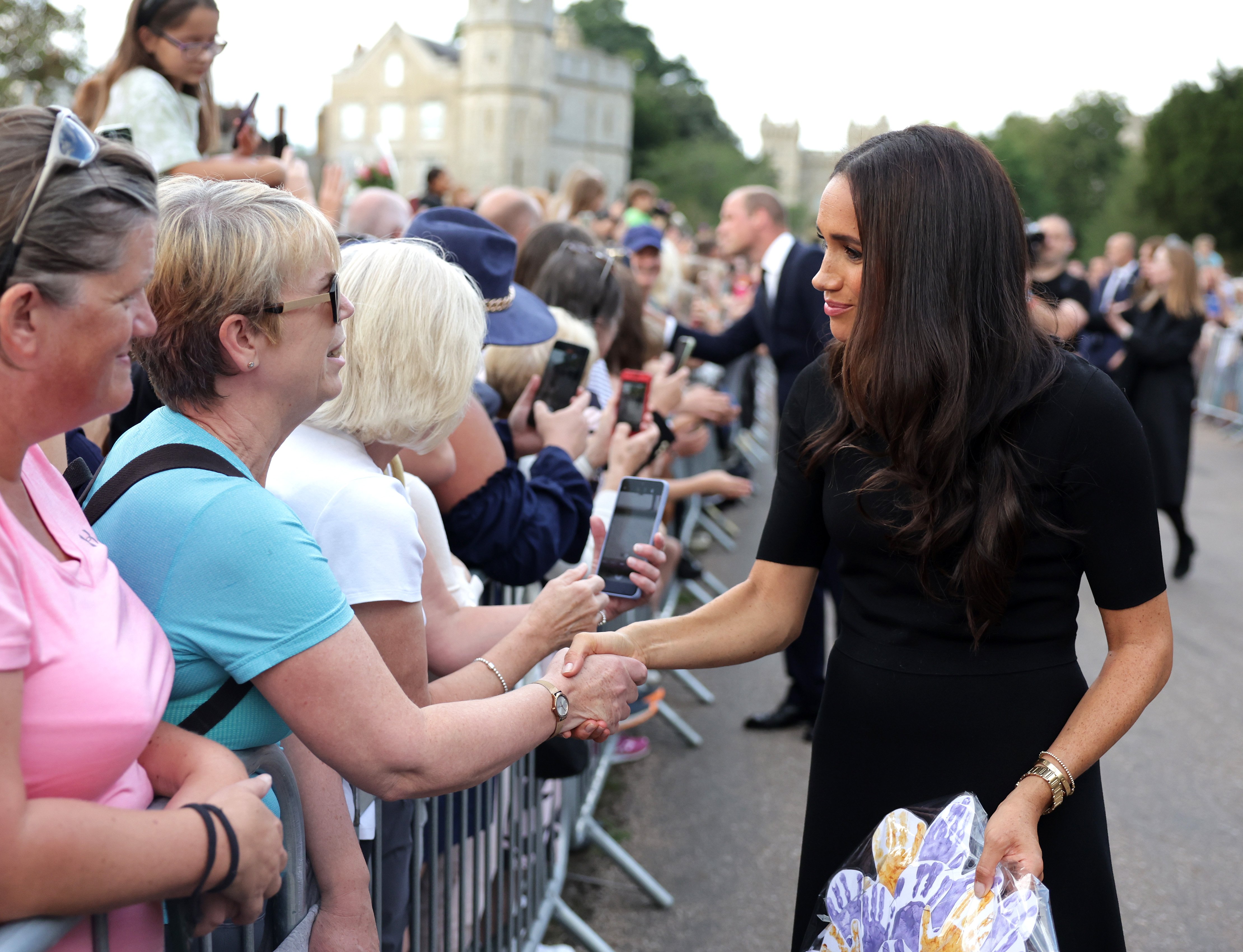 Meghan, Duchess of Sussex, meets public members on the long Walk at Windsor Castle after viewing flowers and tributes to HM Queen Elizabeth on September 10, 2022, in Windsor, England. | Source: Getty Images
