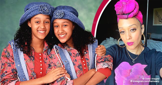 Tia Mowry Poses In A Black And Pink T-shirt And Matching Head Accessory 