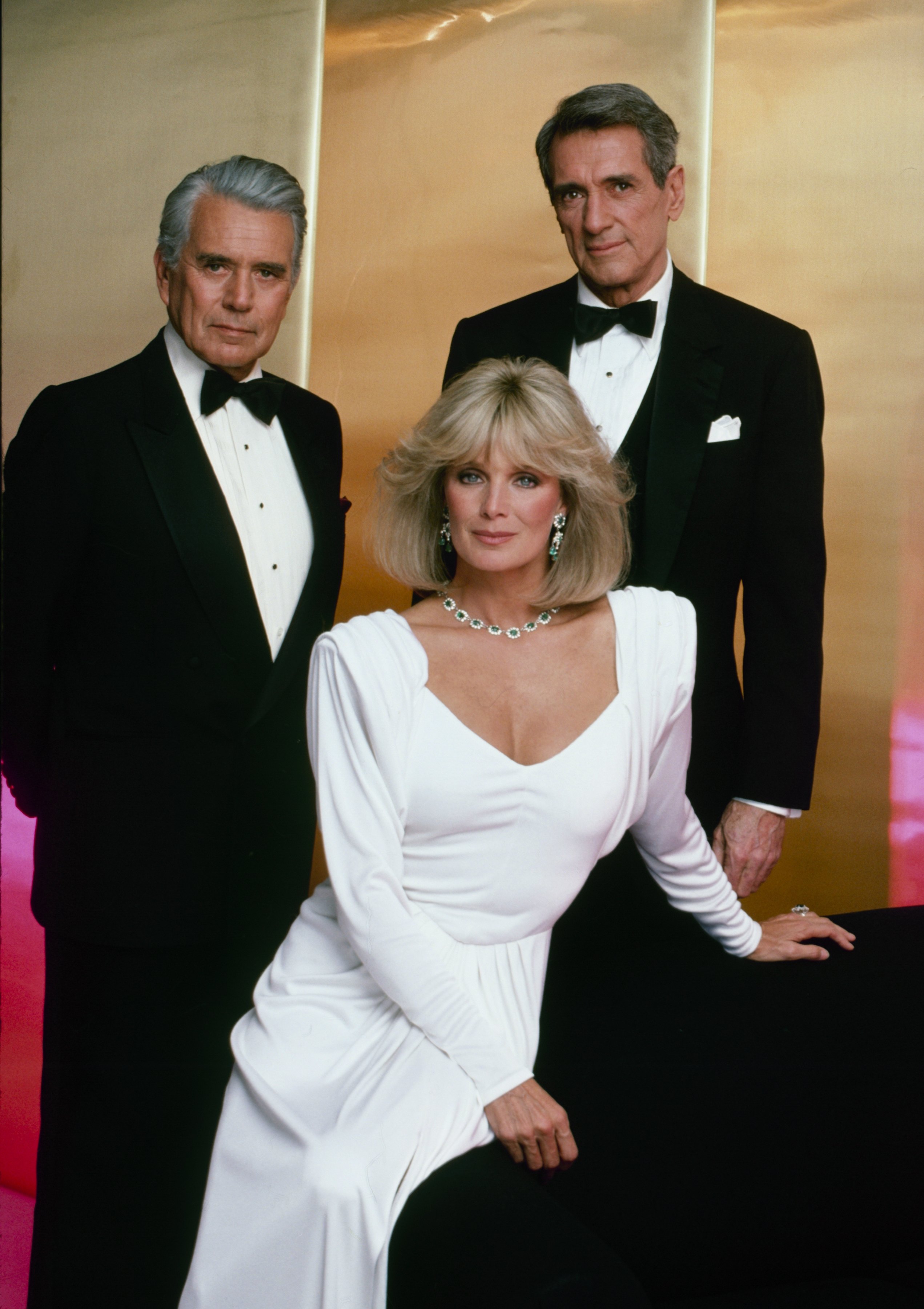John Forsythe, Linda Evans, and Rock Hudson as their characters from "Dynasty" in 1984. | Source: Getty Images