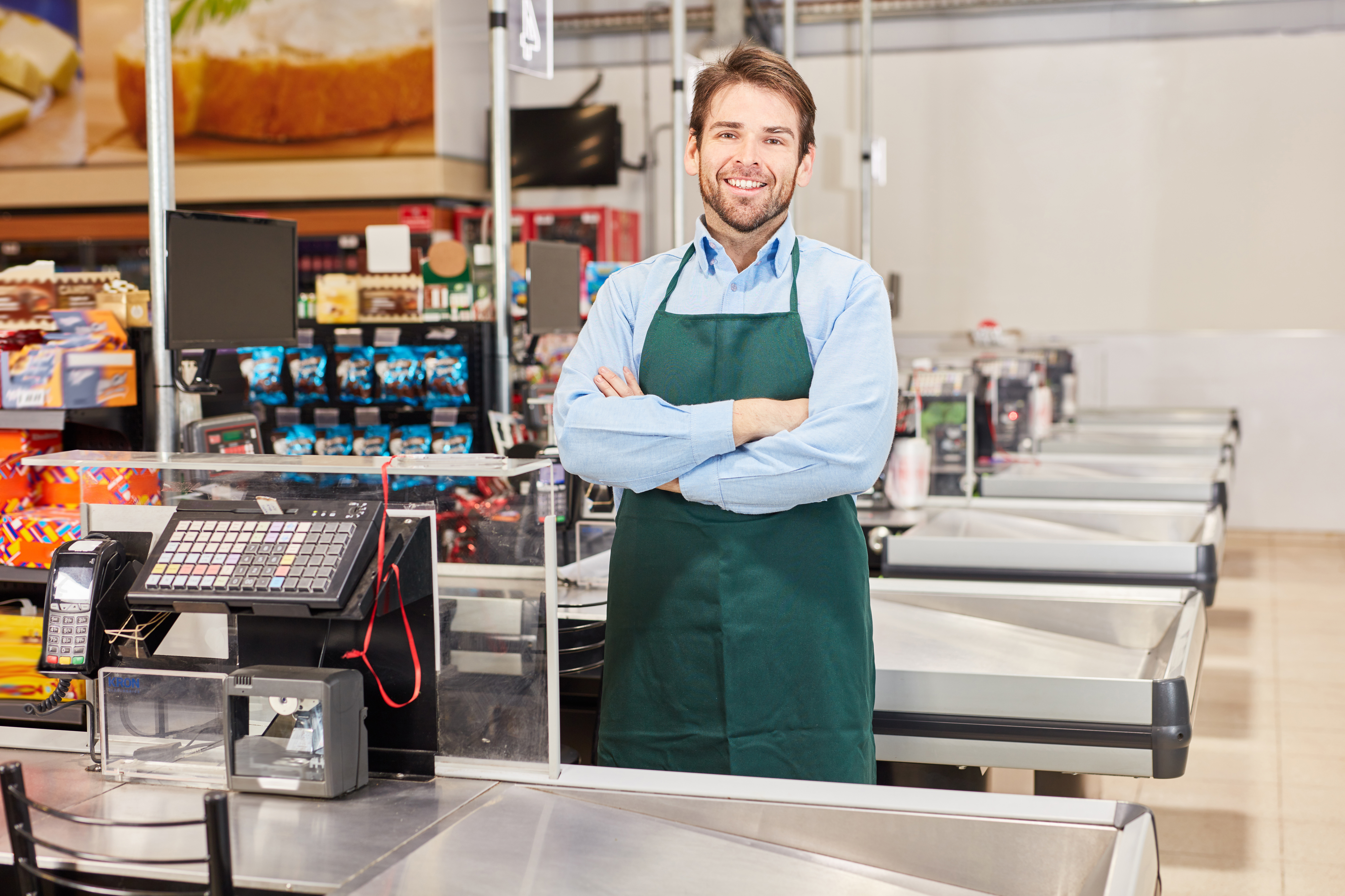 A man working as a cashier | Source: Shutterstock