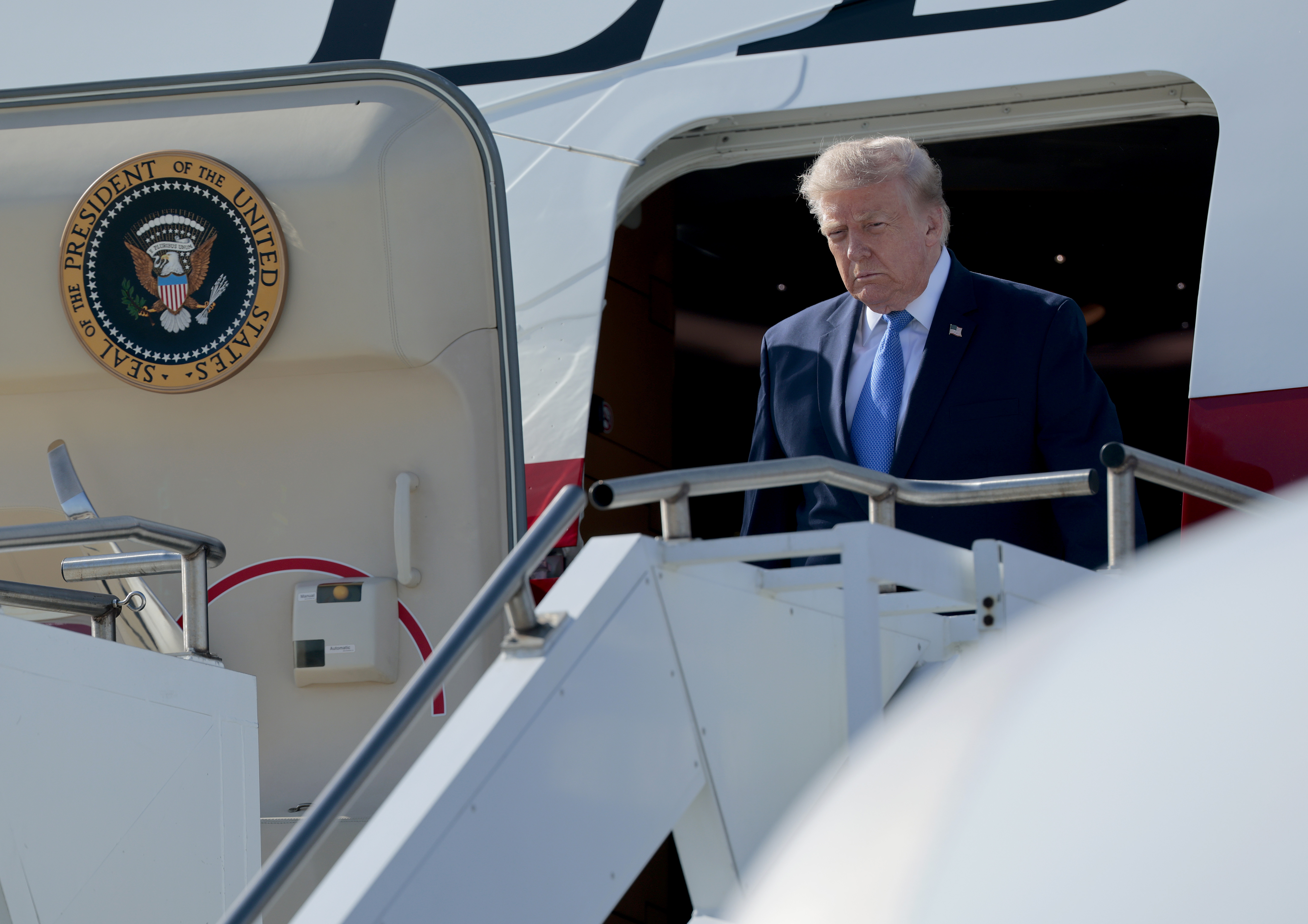 One day earlier in Los Angeles, Trump's hair looked flatter and more restrained as he stepped off Air Force One. The strands were swept back with less height at the front, creating a noticeably different look from the Las Vegas appearance that followed. | Source: Getty Images