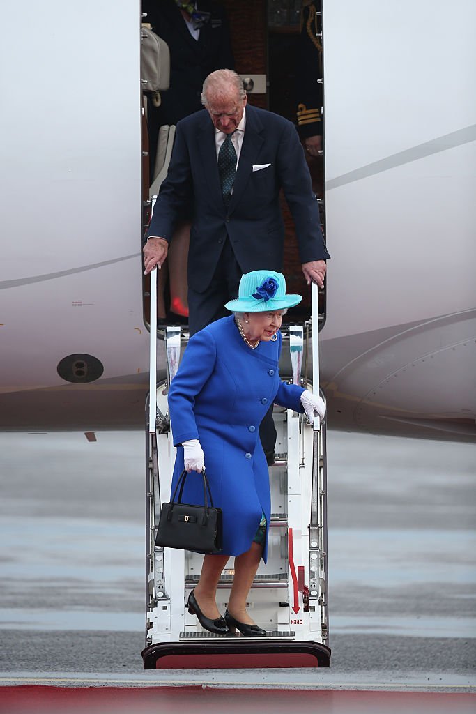 Queen Elizabeth II and Prince Philip, the Duke of Edinburgh, emerge from their plane as they arrive at Tegel airport on the first of their four-day visit to Germany on June 23, 2015, in Berlin, Germany. | Source: Getty Images.
