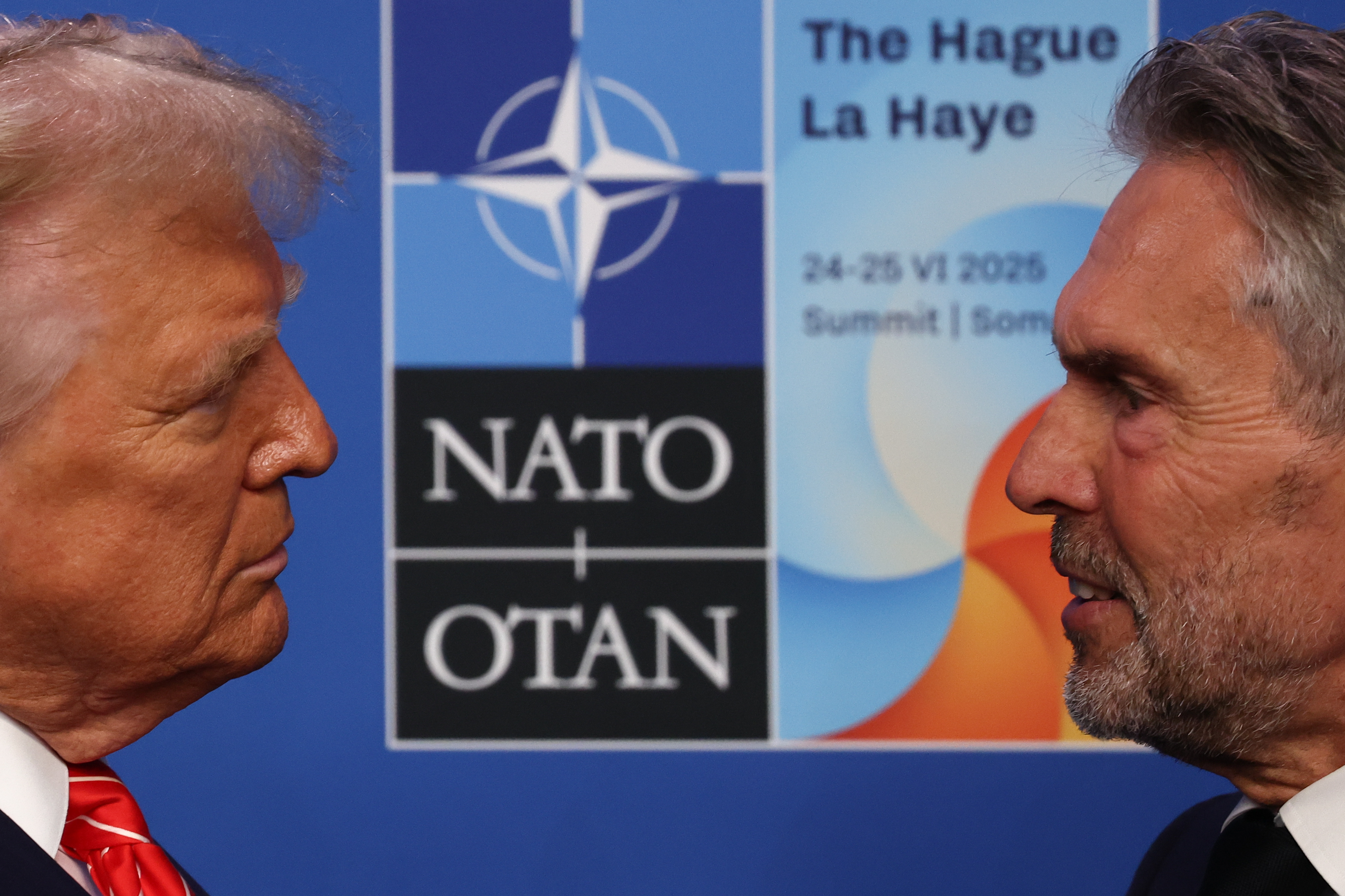 Trump continues with a full slate of high-stakes engagements throughout the day. A candid shot captures a moment of focused exchange as he stands face to face with Schoof, the two appearing deep in what seems to be an intense and purposeful conversation.