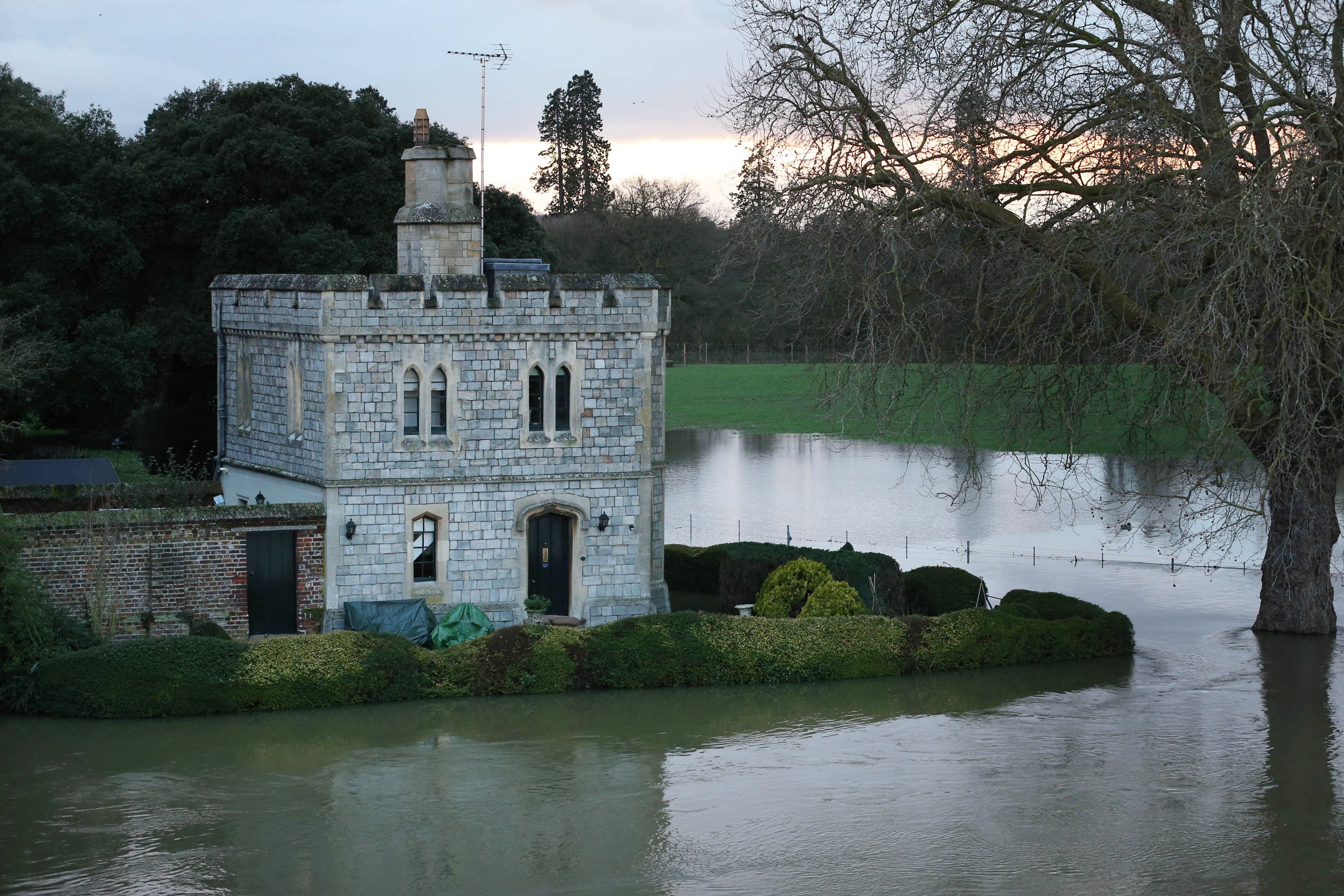 A Royal Lodge in the grounds of Windsor Castle is surrounded by flood water after The river Thames burst it's banks on February 10, 2014 in Datchet, England. | Source: Getty Images
