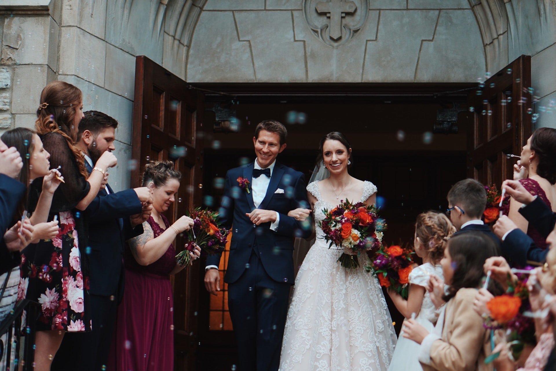 Bride and groom standing between the guests | Source: Unsplash