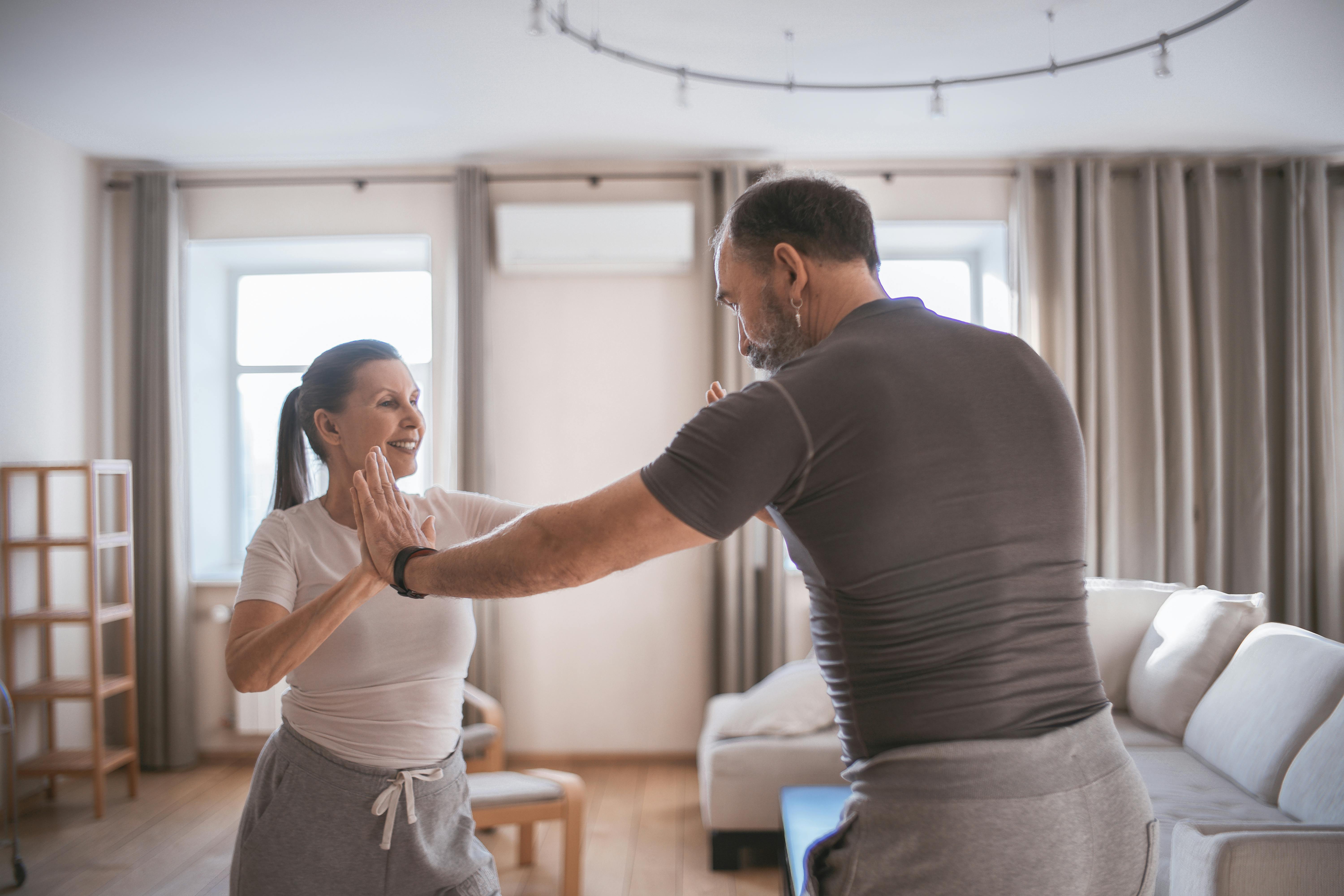 A man and woman dancing at home | Source: Pexels