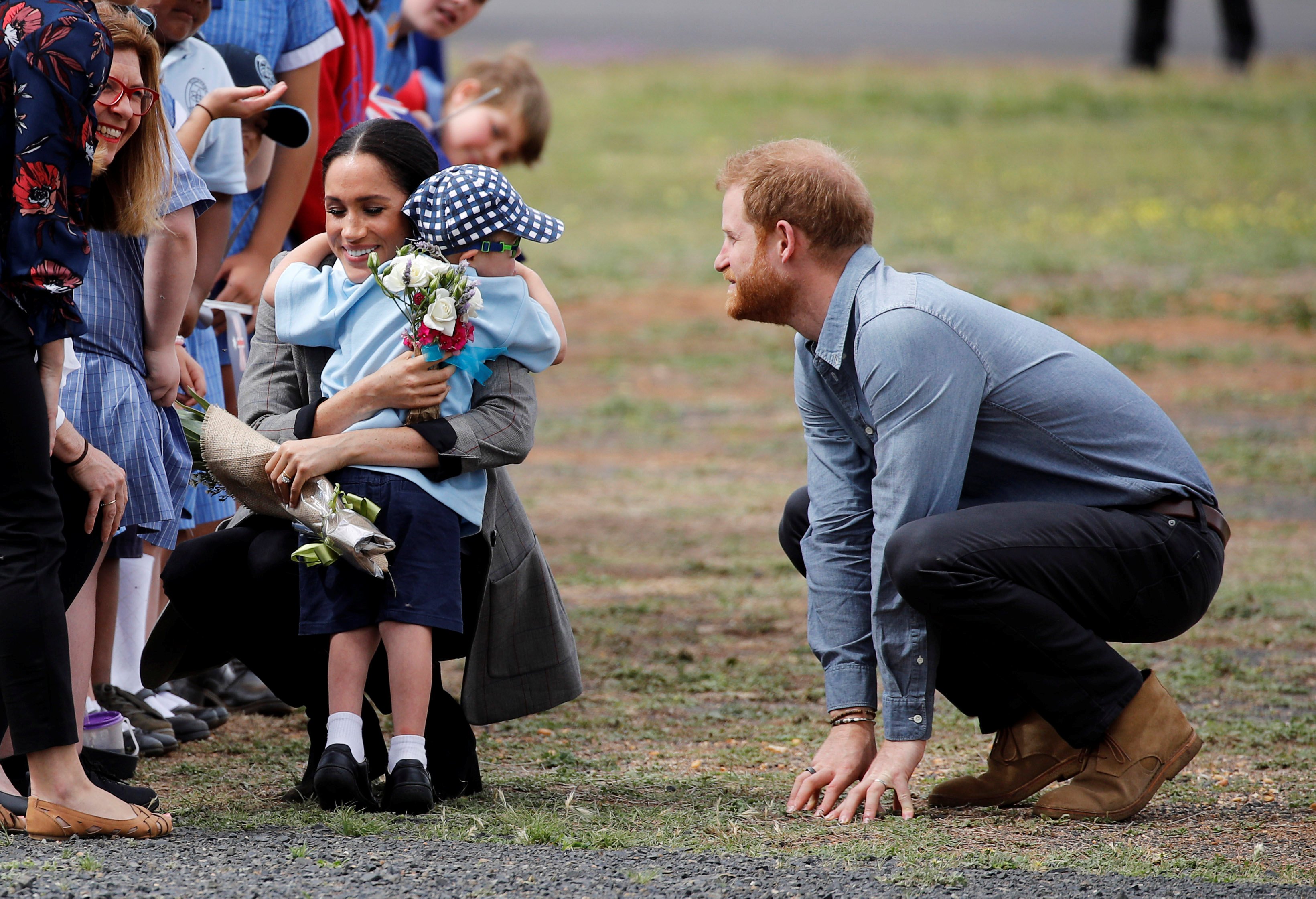 Prince Harry, Duke of Sussex and Meghan, Duchess of Sussex are greeted by five-year-old Luke Vincent as they arrive at Dubbo Airport on October 17, 2018 in Dubbo, Australia | Source: Getty Images