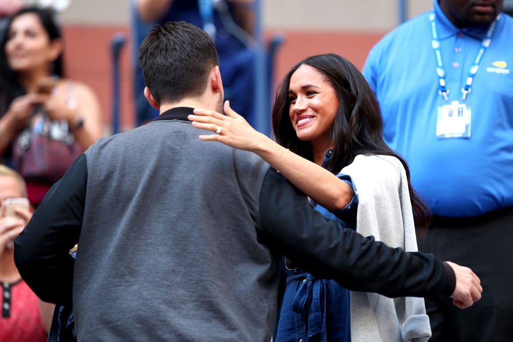 Alexis Ohanian embraces Meghan before the Women's Singles final match. | Source: Getty Images