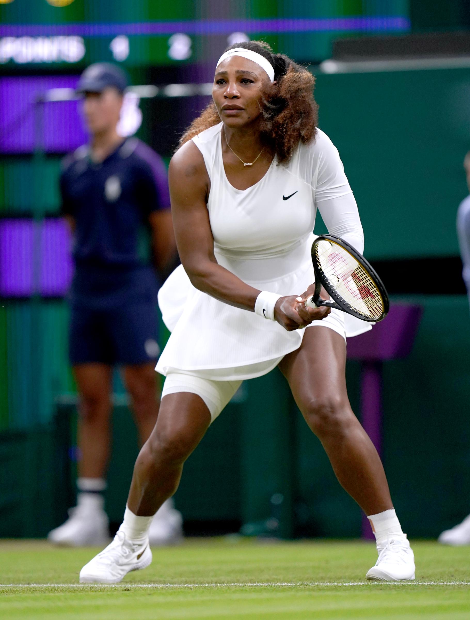 At Wimbledon in June 2021, Serena Williams stepped onto the court in a classic white tennis dress and matching headband. She stayed focused while competing in the first round of the tournament.