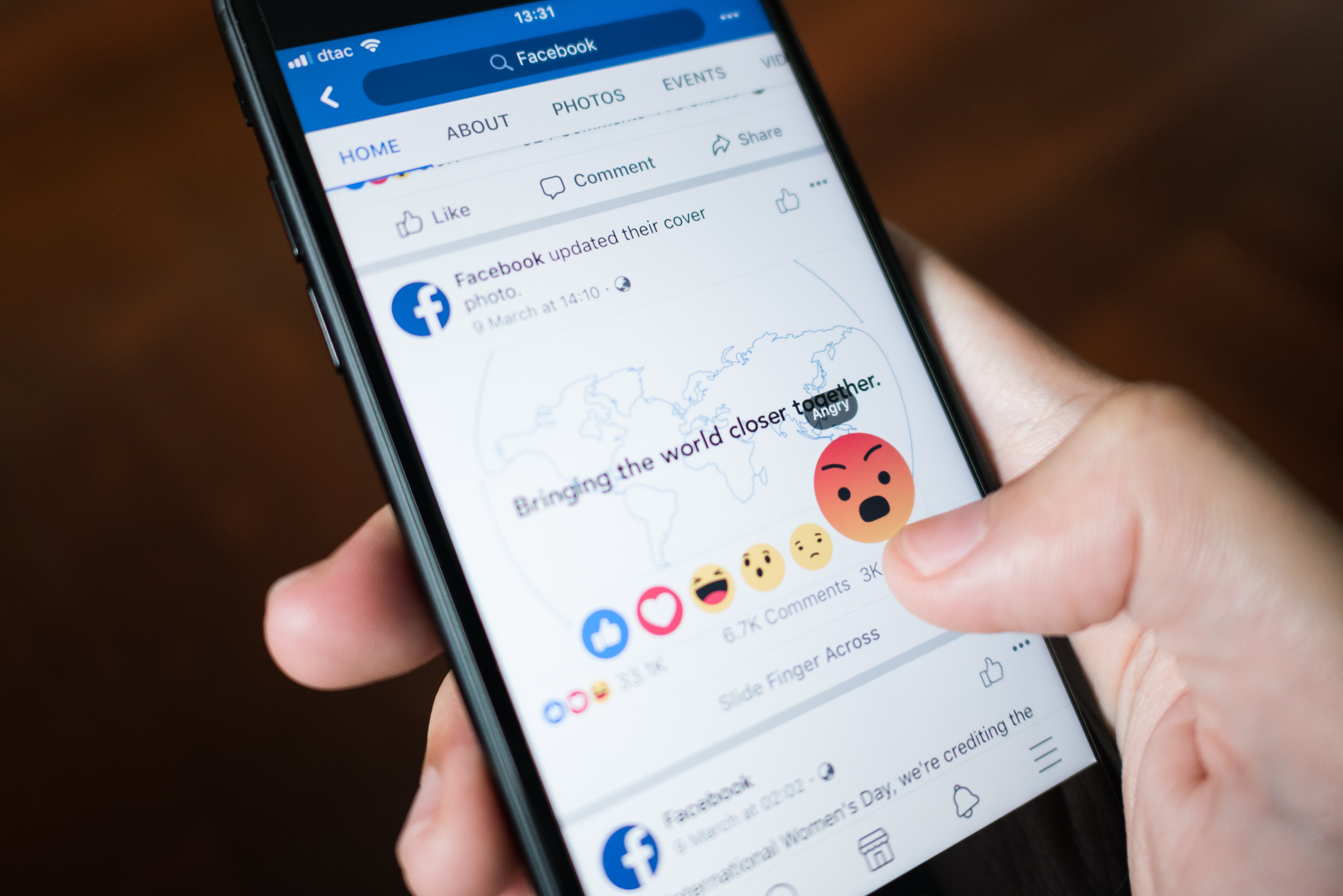 Woman using Facebook on a mobile phone. | Photo: Shutterstock