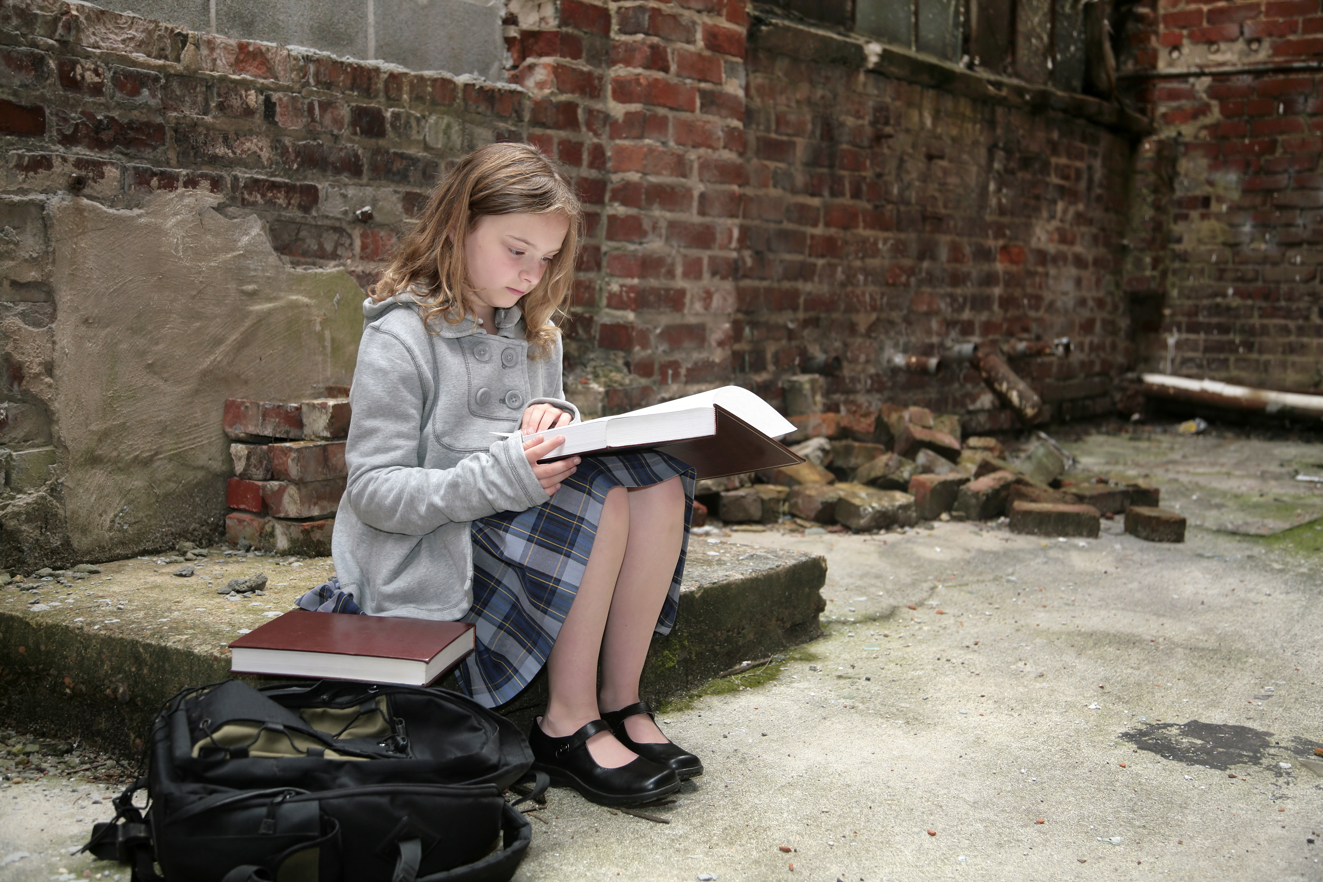 Girl is studying in abandoned building | Source: Shutterstock