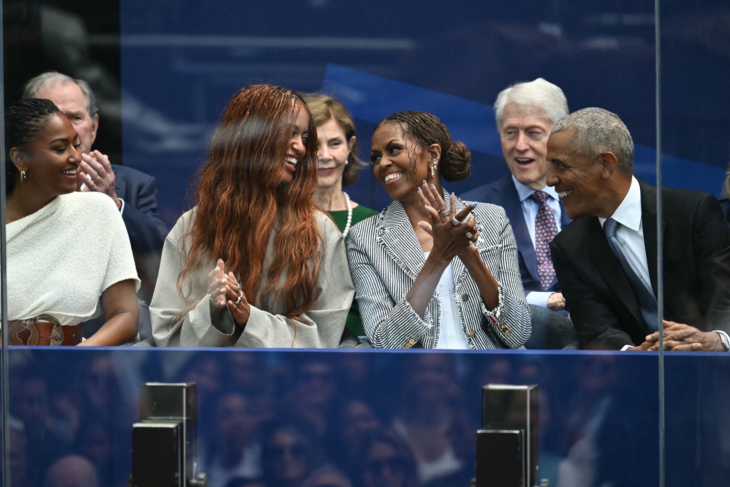At one point, Malia Obama used her long hair to cover up as she walked alongside her family at the high-profile gathering. In this photo, the family is seen sitting together during the opening of the Barack Obama Presidential Center in Chicago, Illinois, on June 18, 2026. | Source: Getty Images