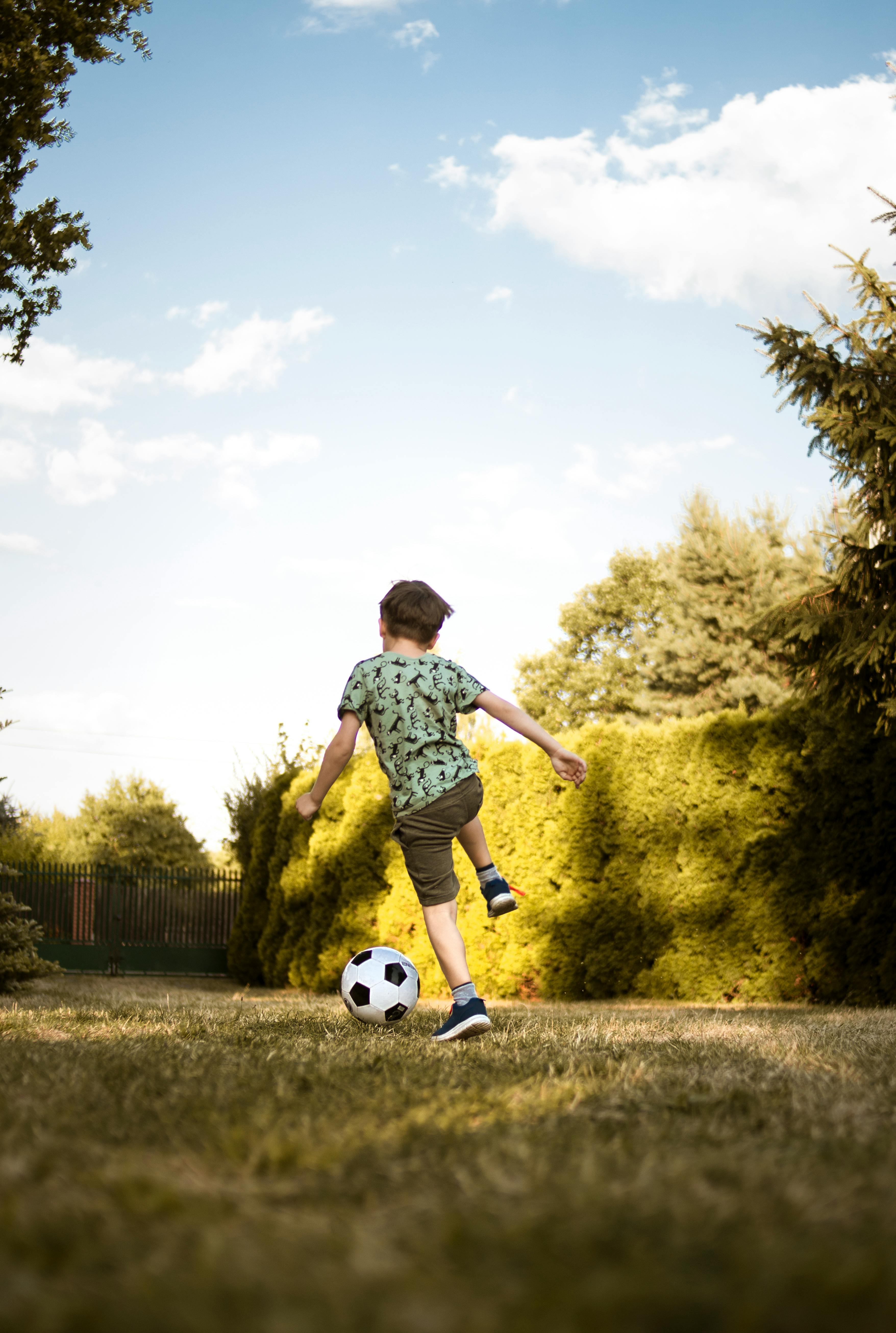 A boy playing with a soccer ball | Source: Pexels