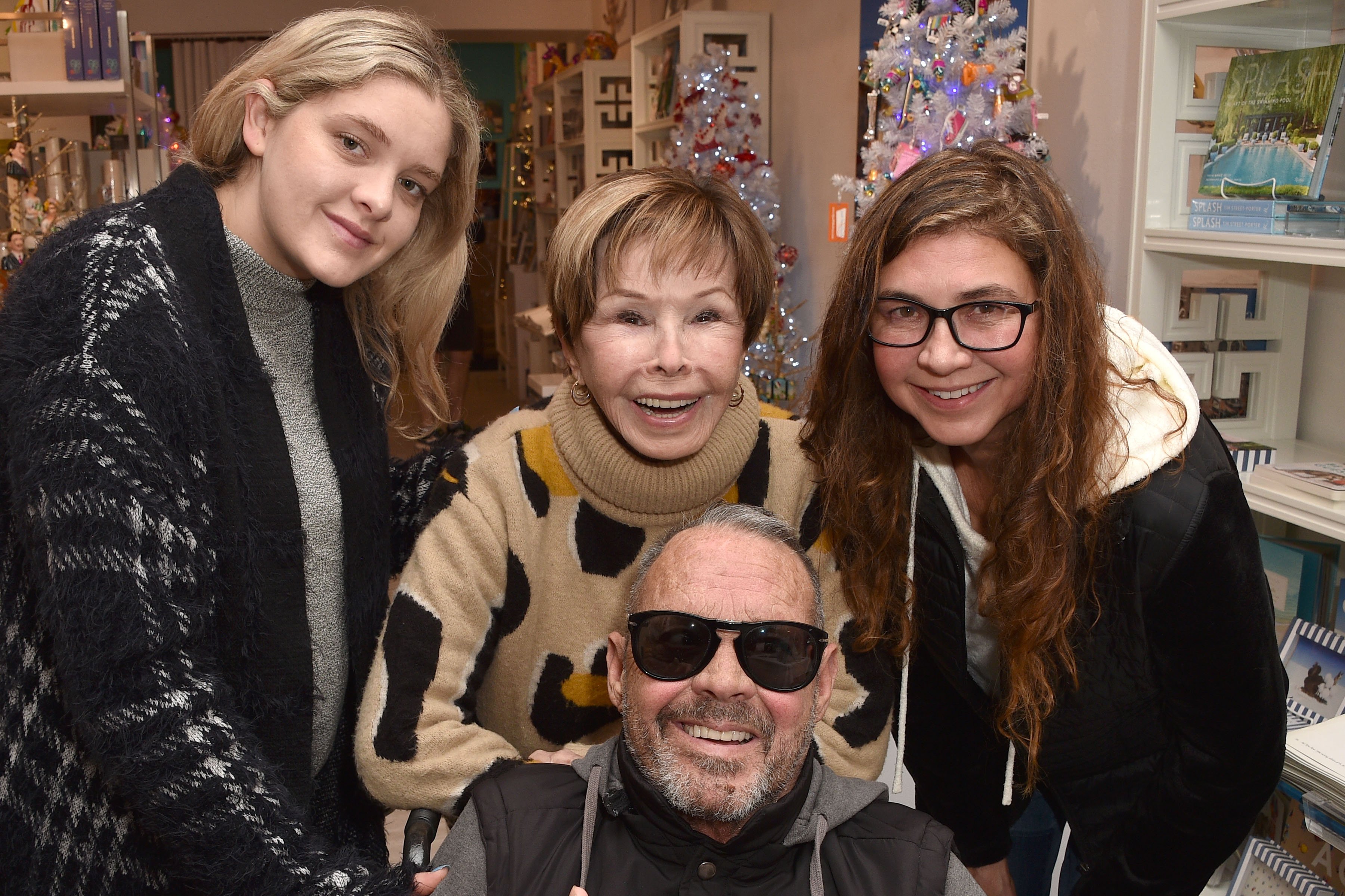 Madison Neile McQueen, Chad McQueen, Neile Adams McQueen, and a guest at Neile Adams McQueen's book signing at Just Fabulous Palm Springs on December 11, 2022, in Palm Springs, California | Source: Getty Images