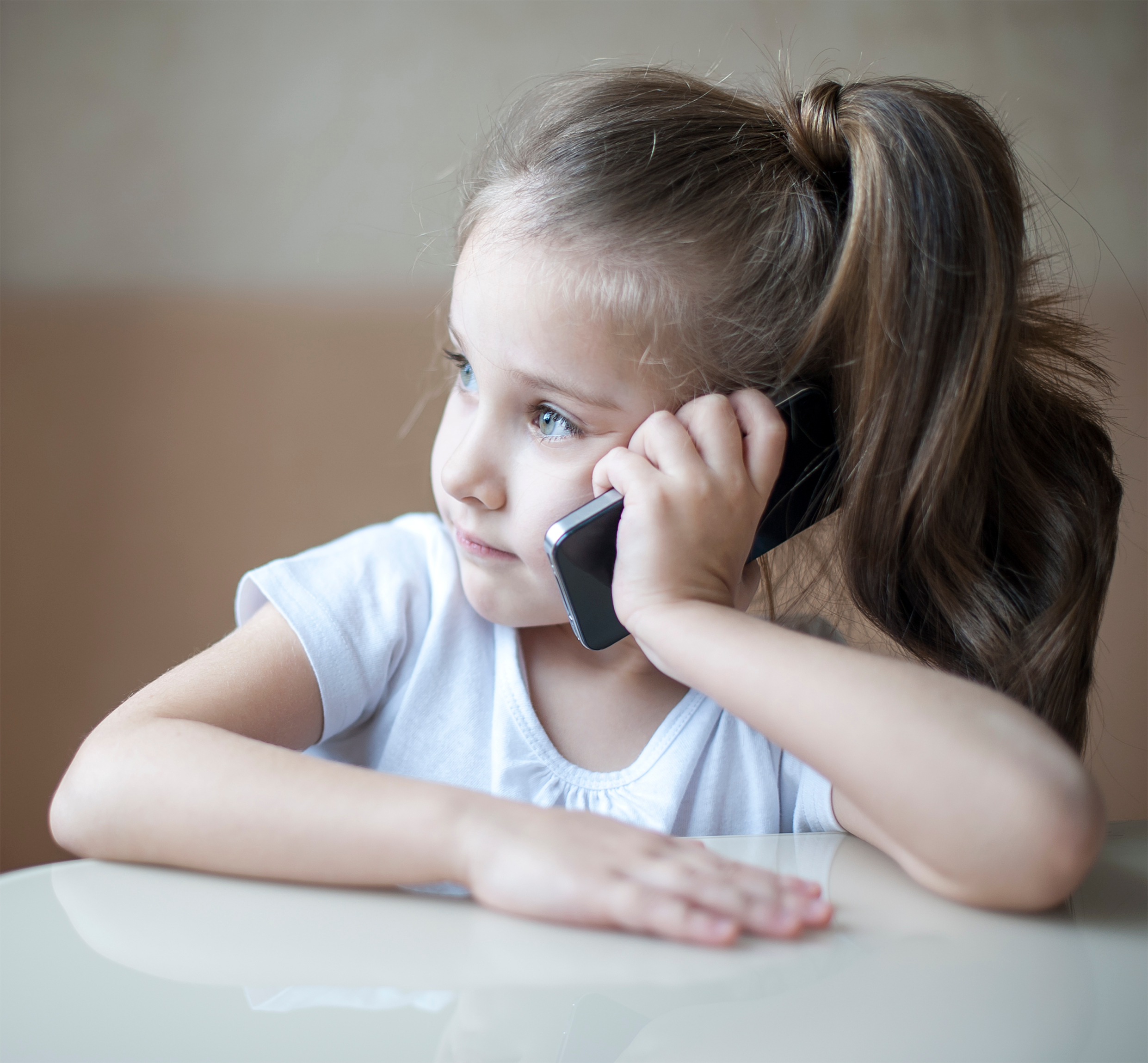 Little girl talking on phone | Source: Shutterstock.com