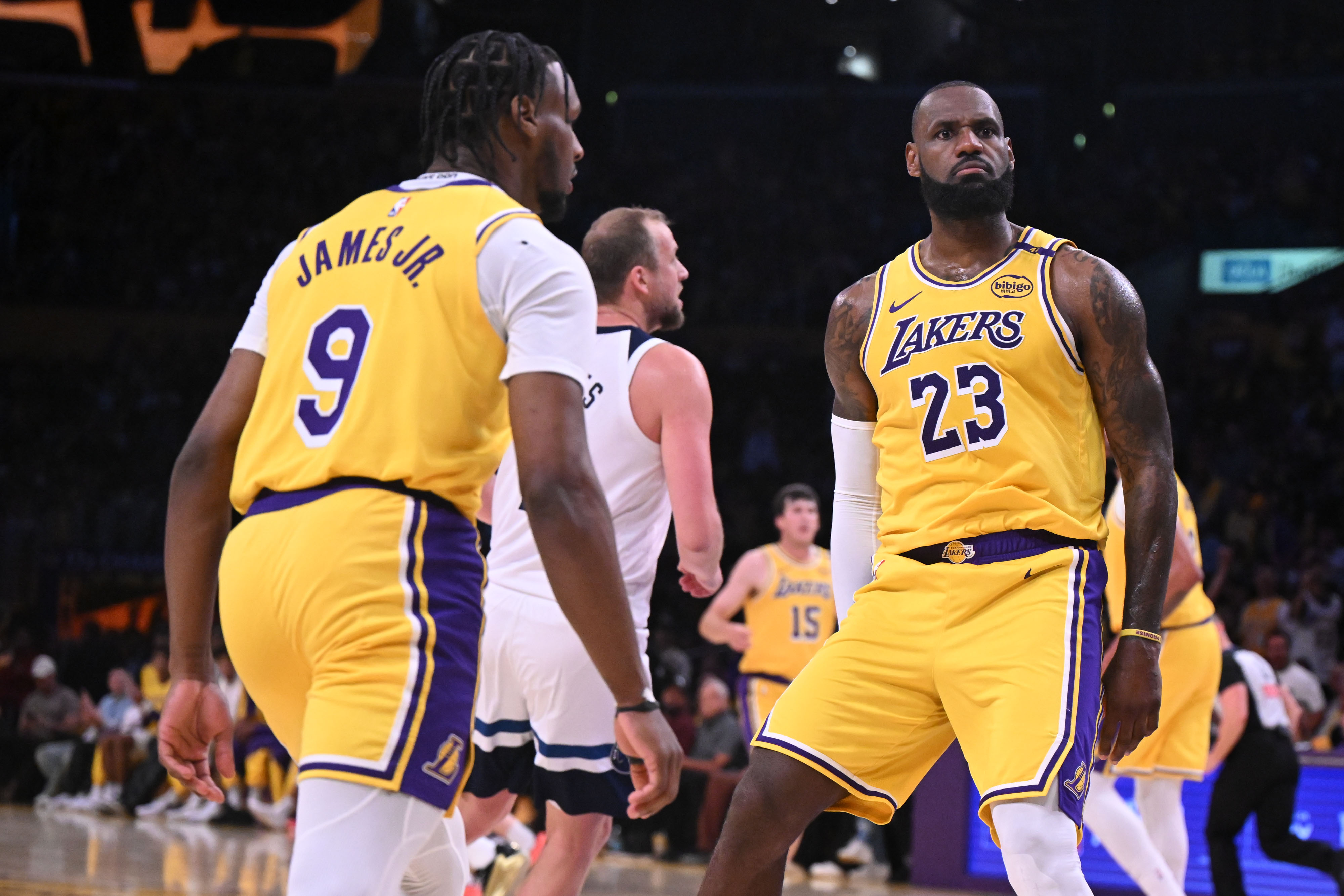 LeBron James reacts after slamming in two points as Bronny James looks on during second quarter action on October 22, 2024 | Source: Getty Images