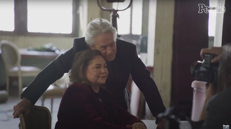 Kathleen Turner and Michael Douglas posing together during an interview posted on May 26, 2021 | Source: YouTube/People